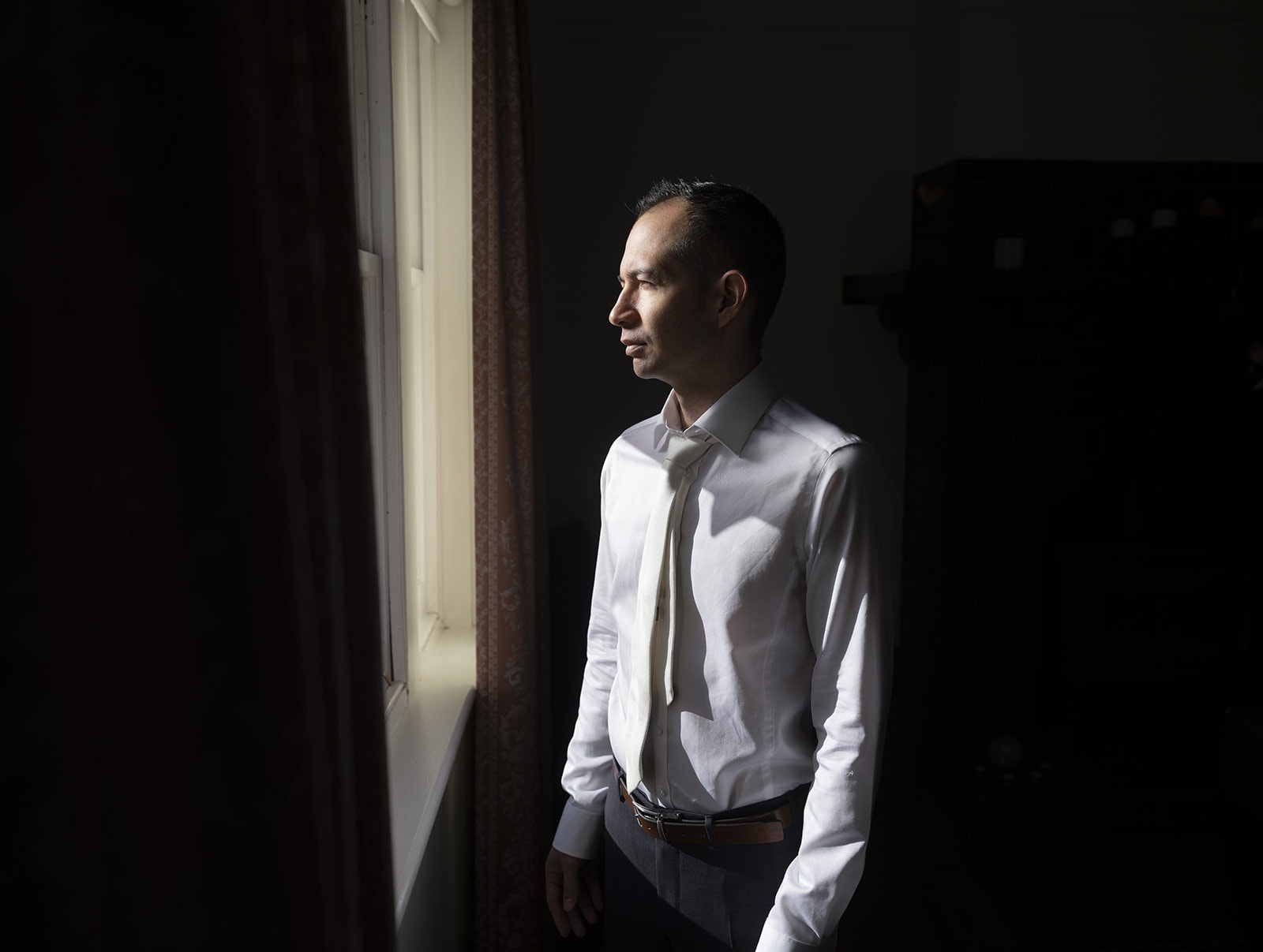 coriole wines wedding - marielle & brendan 5 Moody shot of groom looking out window