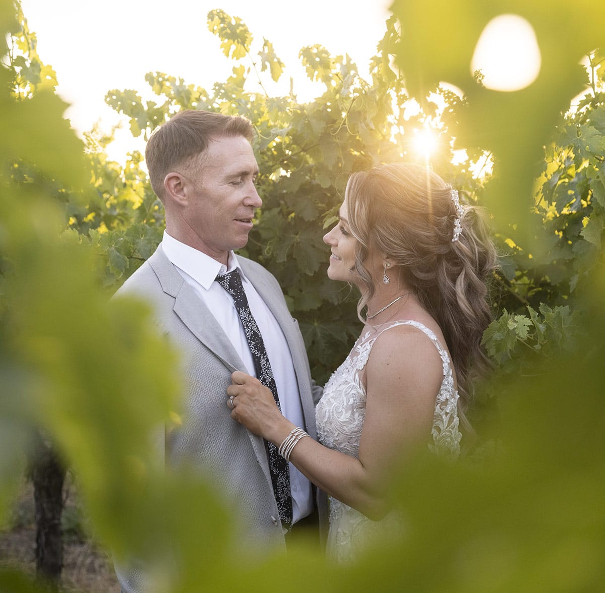big easy radio wedding - leanne & evan 59 Sun shining through vines on bride and groom