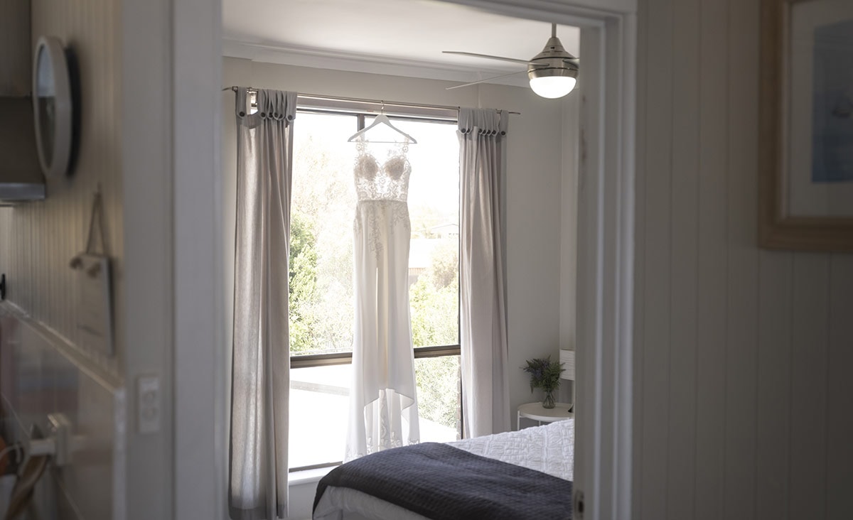 big easy radio wedding - leanne & evan 1 Wedding dress hanging in room