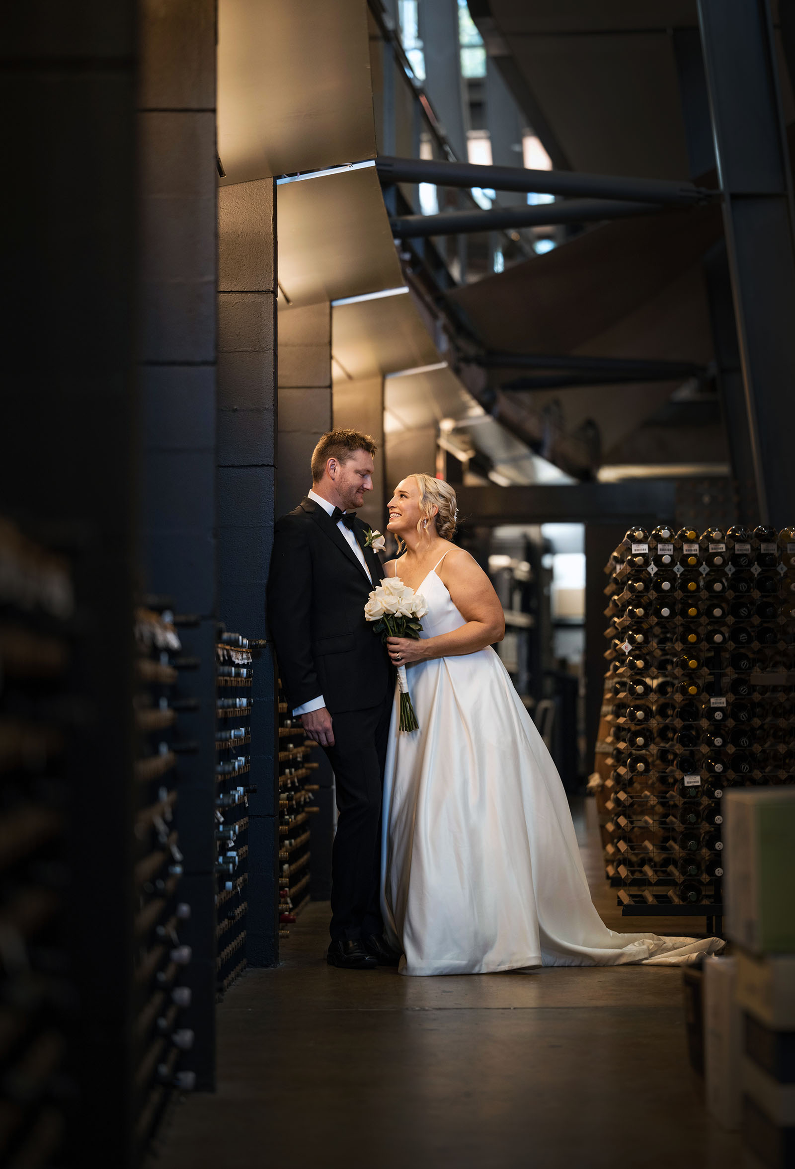 adelaide botanic gardens cycad collection wedding - joanne & blake 35 Bride and groom in the Adelaide Wine center cellar
