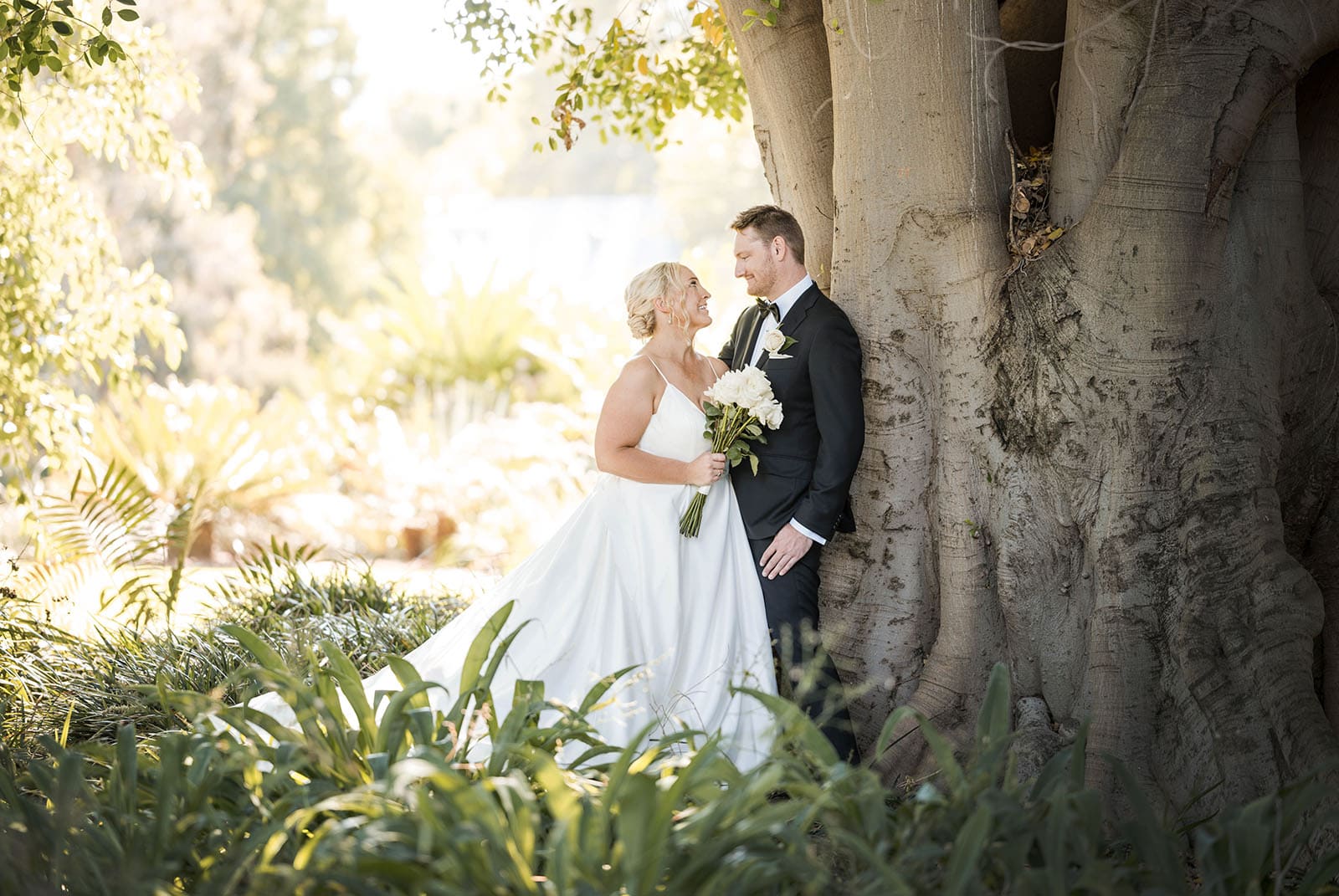 adelaide botanic gardens cycad collection wedding - joanne & blake 25 Bride and groom leaning against large tree