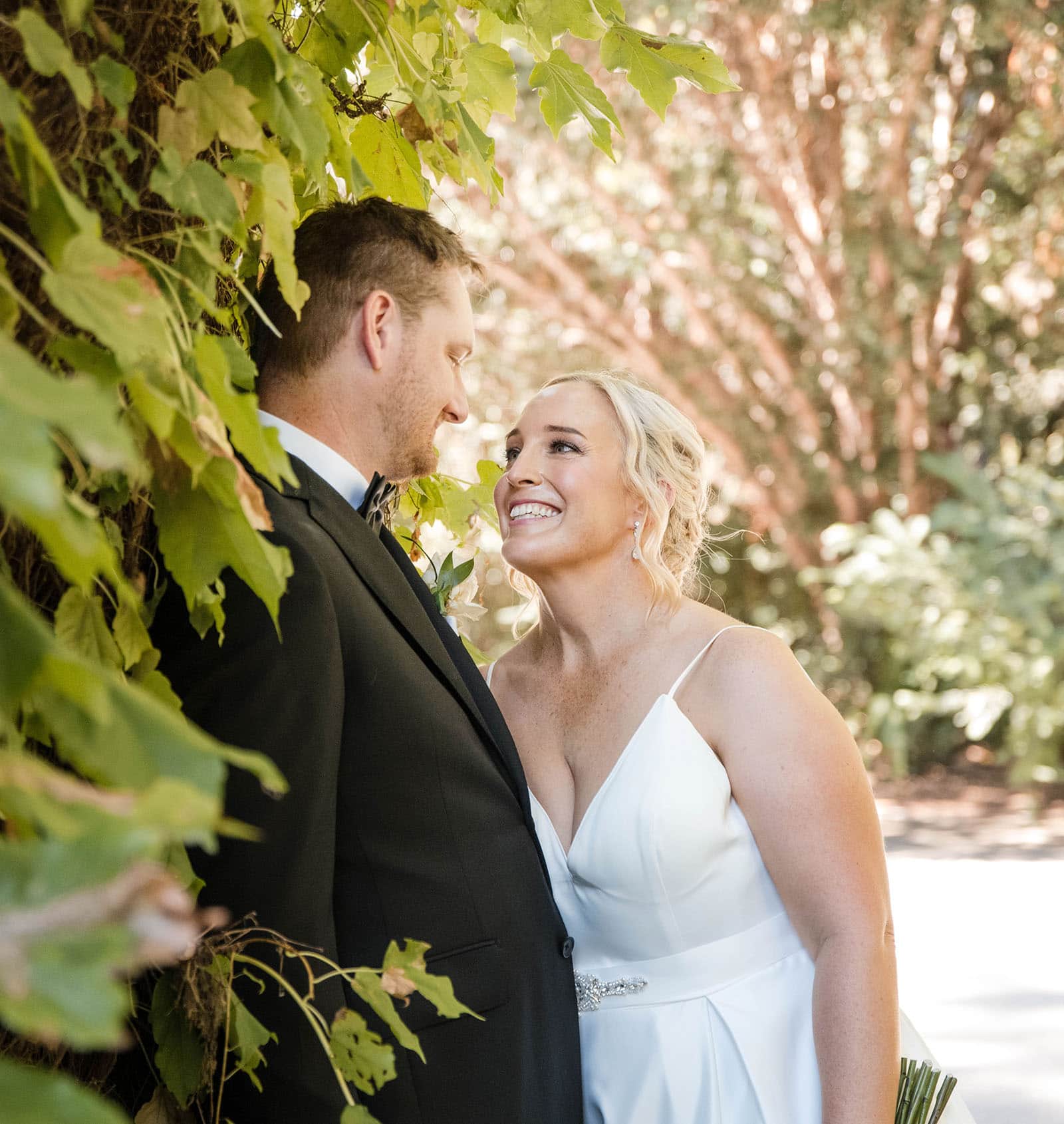 adelaide botanic gardens cycad collection wedding - joanne & blake 32 Bride and groom leaning against the friendship gates