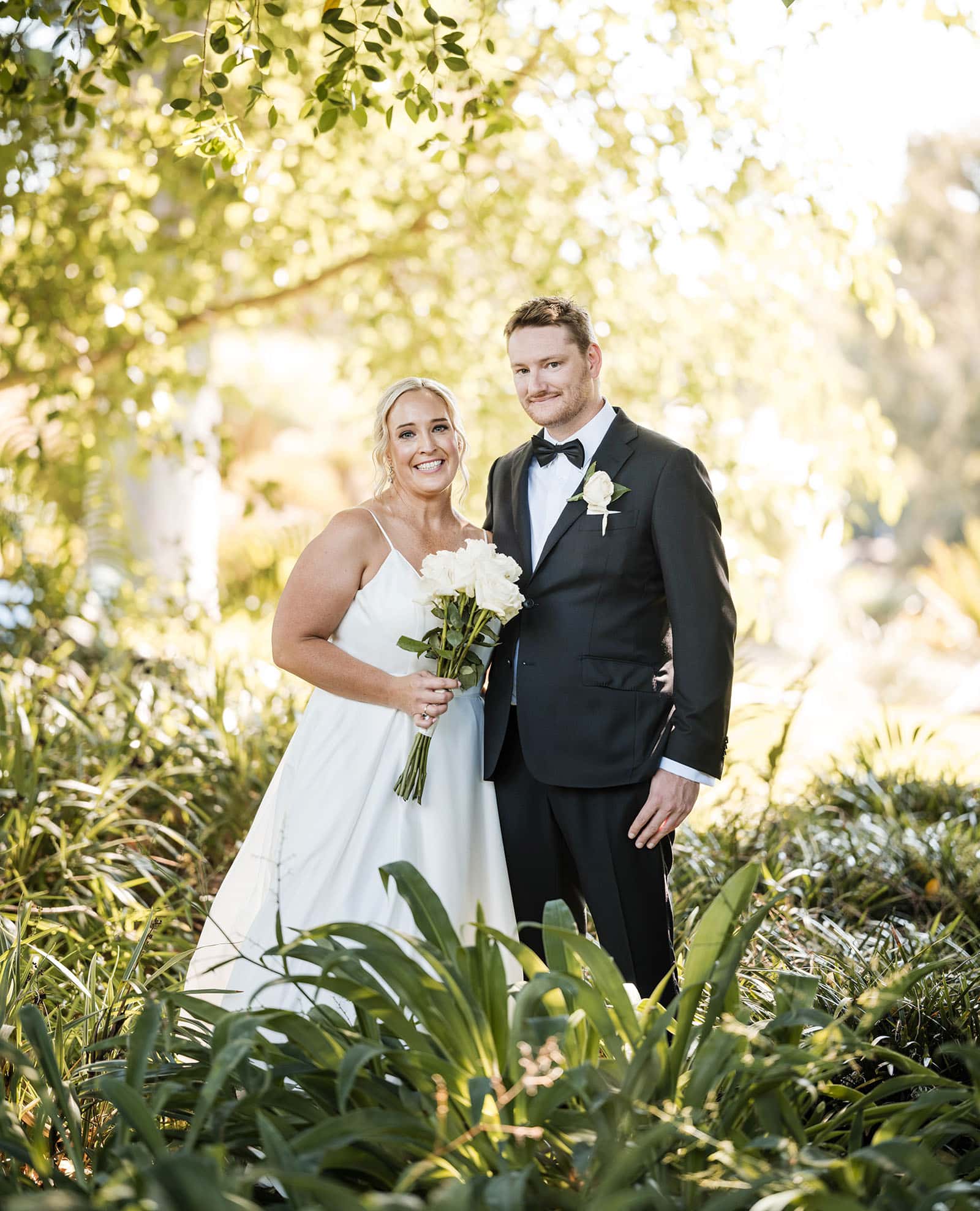 adelaide botanic gardens cycad collection wedding - joanne & blake 24 Bride and groom looking at camera in foliage