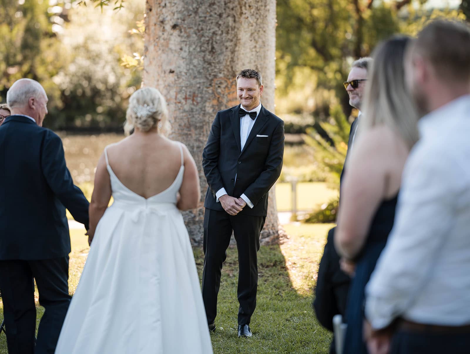 adelaide botanic gardens cycad collection wedding - joanne & blake 5 Groom watching his bride arrive at Cycad collection wedding