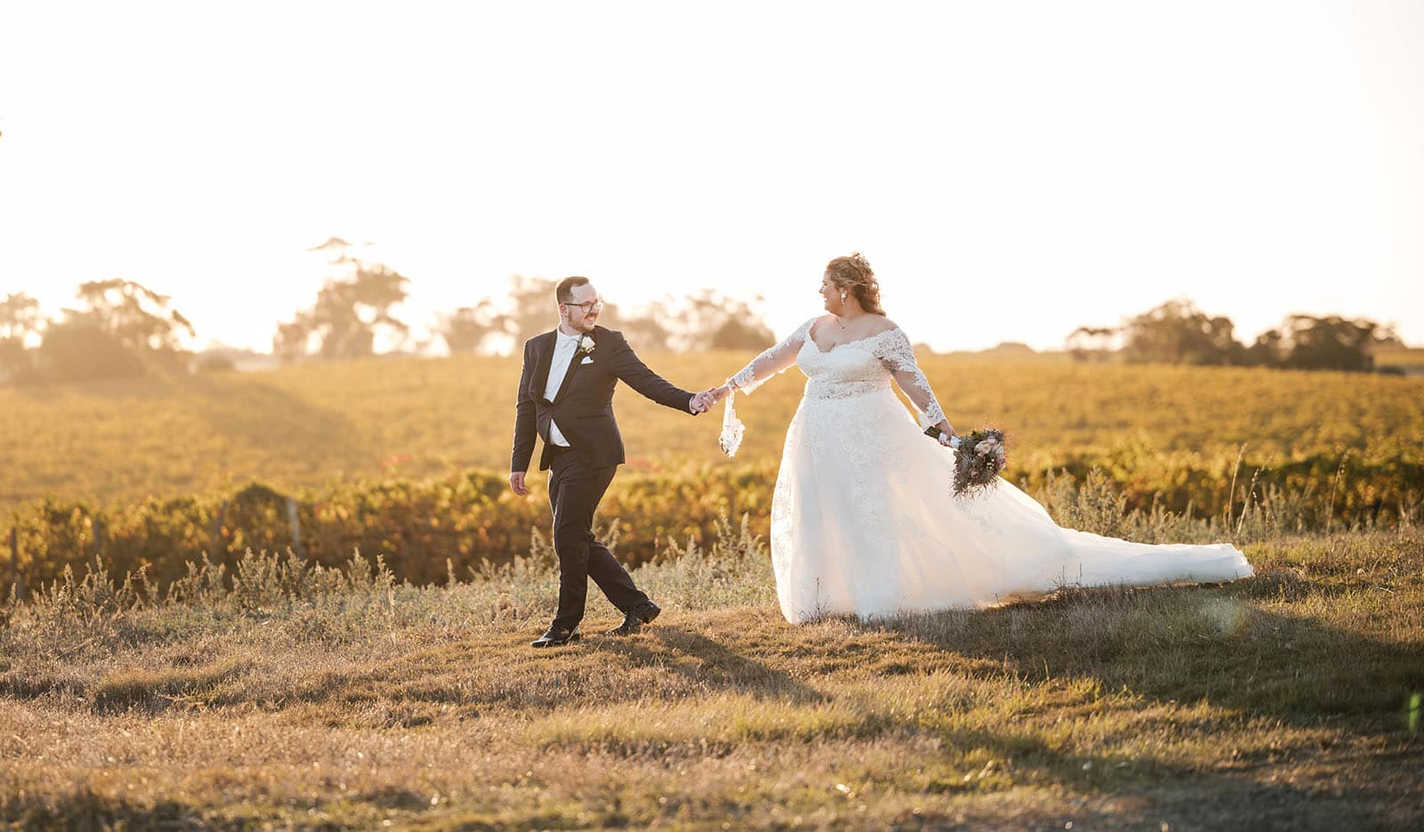 mclaren vale ekhidna wines wedding - kait & brayden 48 Groom dragging bride along in sunset