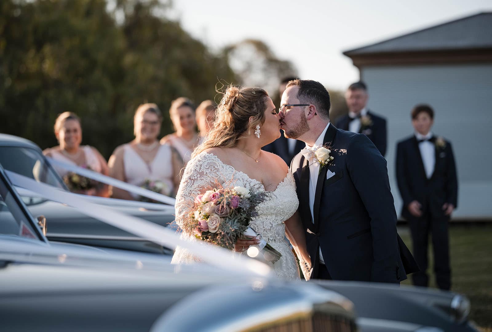 mclaren vale ekhidna wines wedding - kait & brayden 39 bride and groom share a kiss with cars