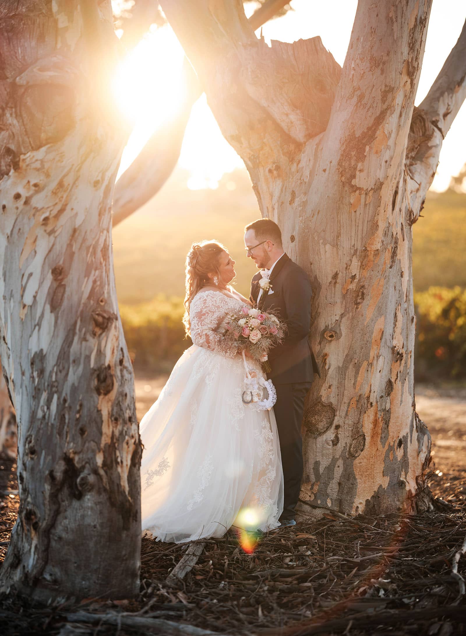 mclaren vale ekhidna wines wedding - kait & brayden 50 Bride snad groom inbetween gumtrees at sunset