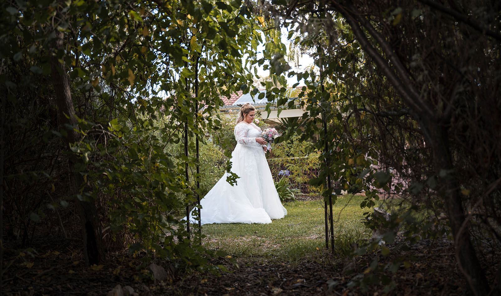 mclaren vale ekhidna wines wedding - kait & brayden 26 Bride standing looking through foliage