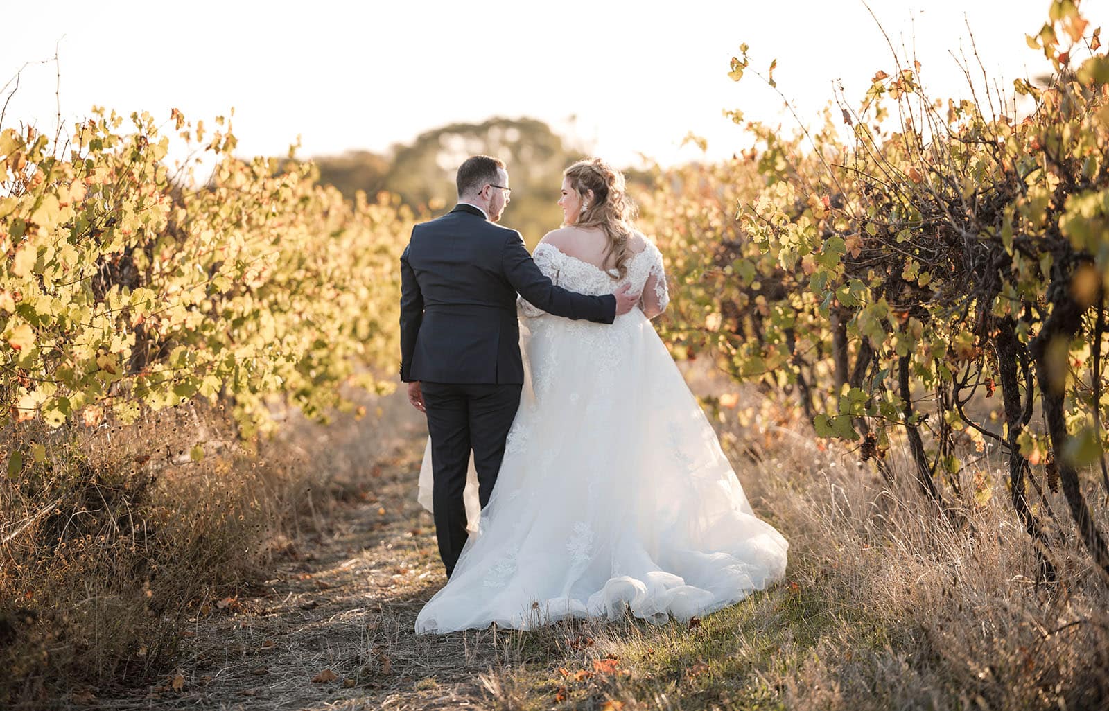 mclaren vale ekhidna wines wedding - kait & brayden 44 Groom hugging bride walking