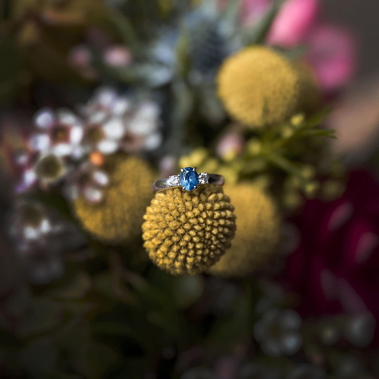 darwin's dudley point wedding - melanie & kerry 4 Blue engagement ring on yellow flowers