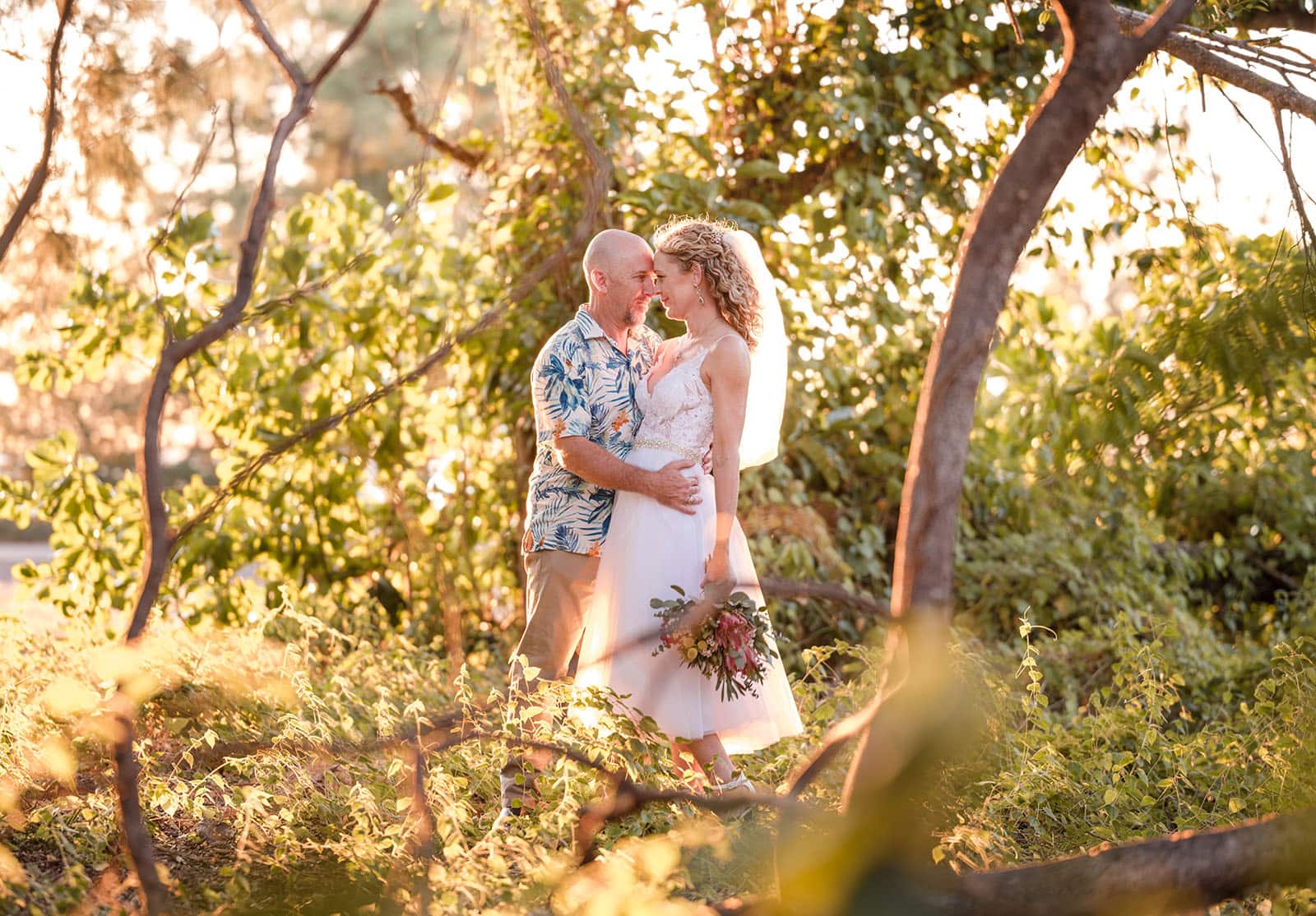 darwin's dudley point wedding - melanie & kerry 44 Bride and groom share embrace surrounded by foliage