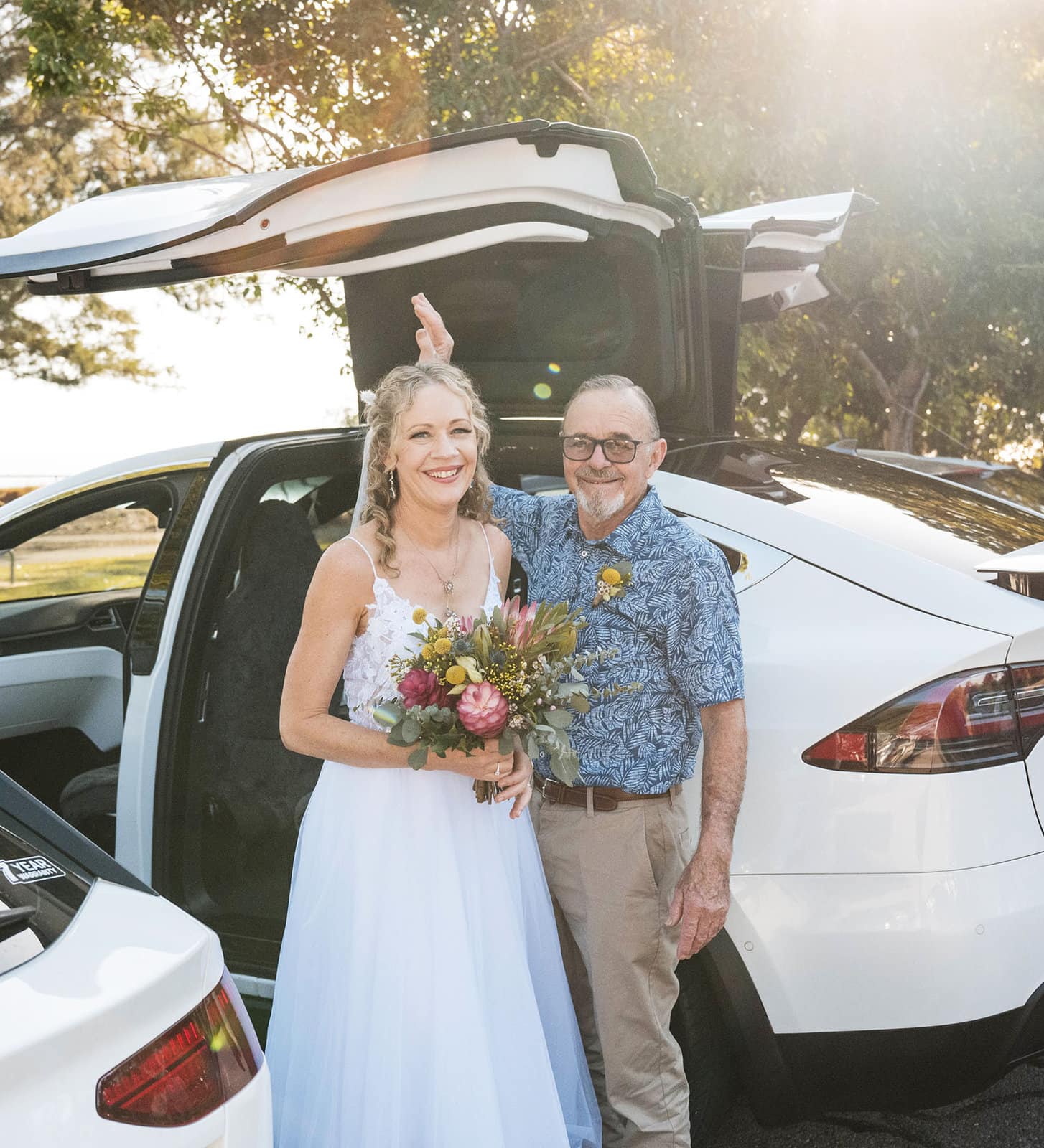 darwin's dudley point wedding - melanie & kerry 23 Posing in front of Tesla wedding car