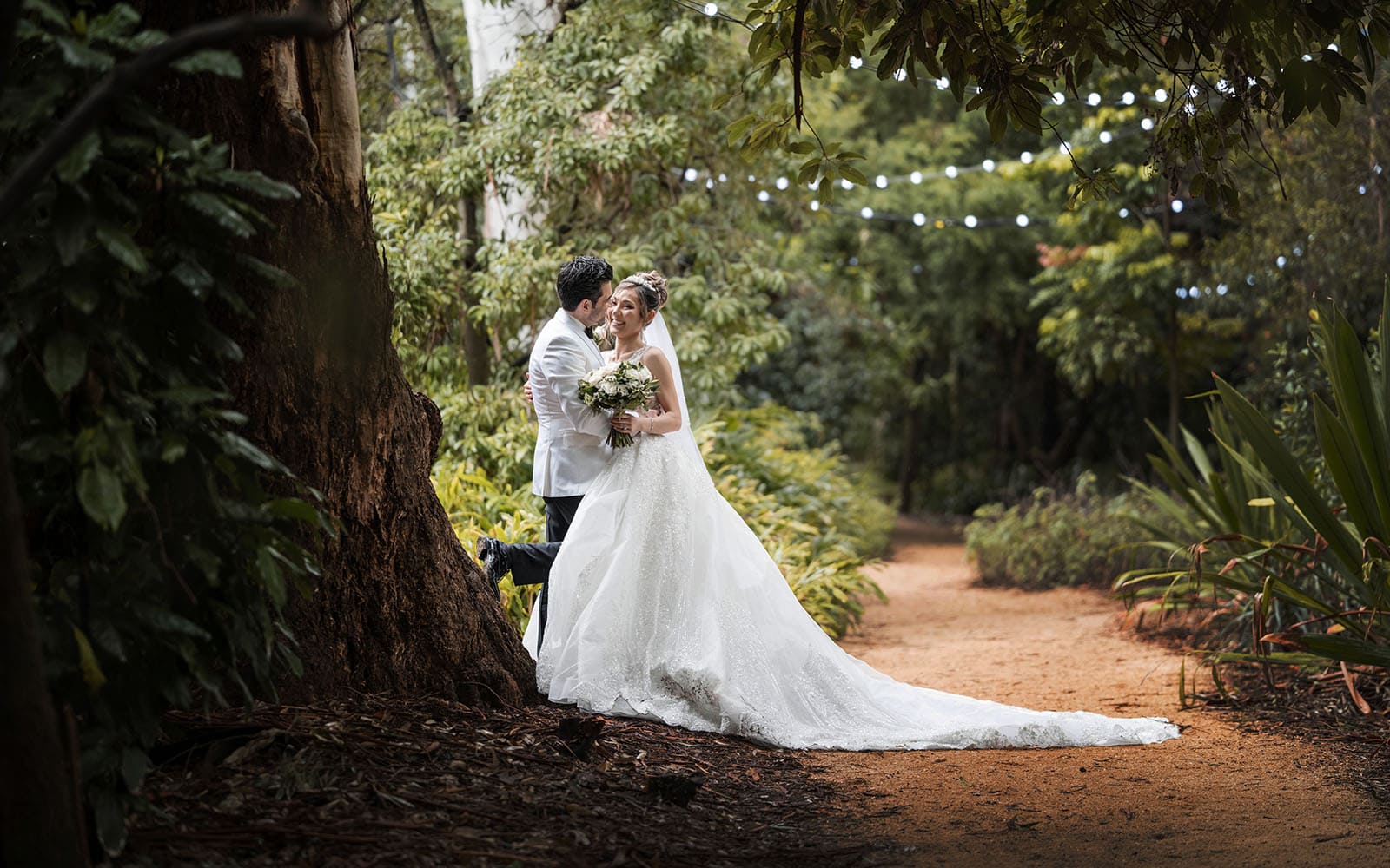 adelaide bridal photoshoot and reception - emre & sara 30 bride and groom leaning on tree with fairy lights
