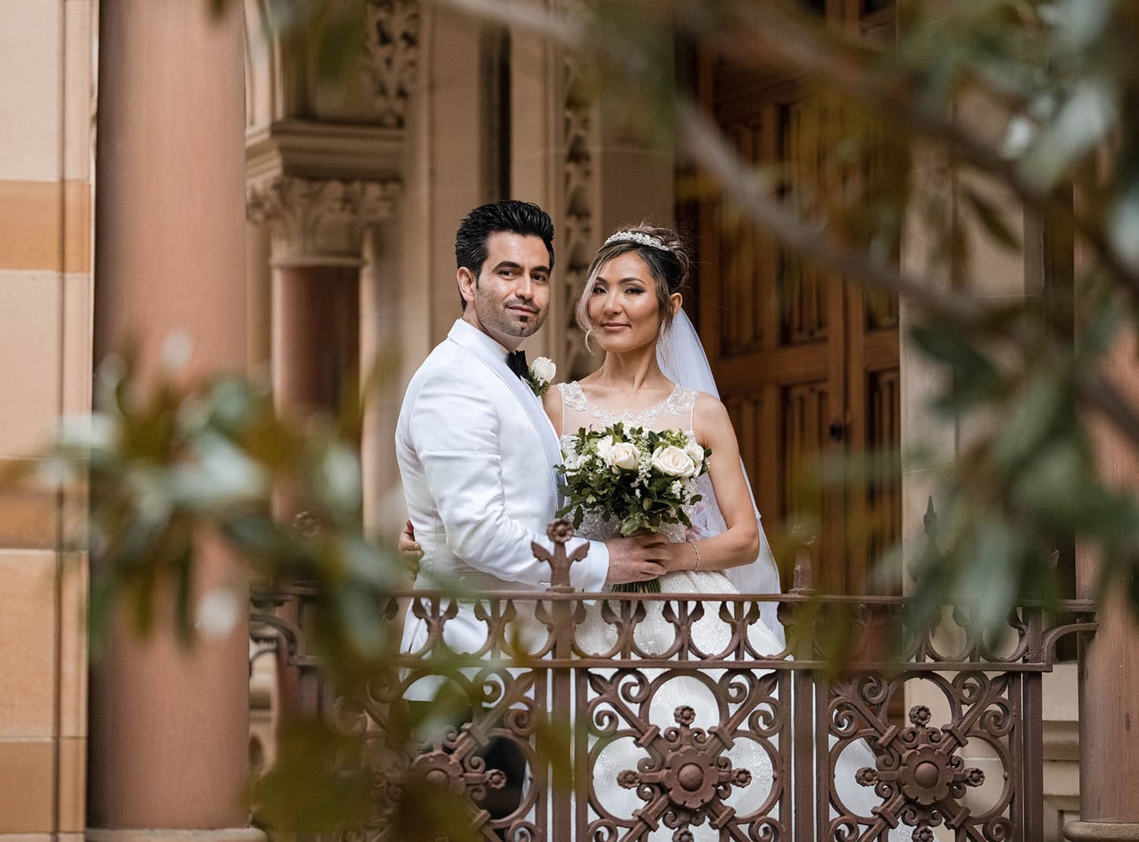 adelaide bridal photoshoot and reception - emre & sara 34 Bride and groom through foliage and doorway