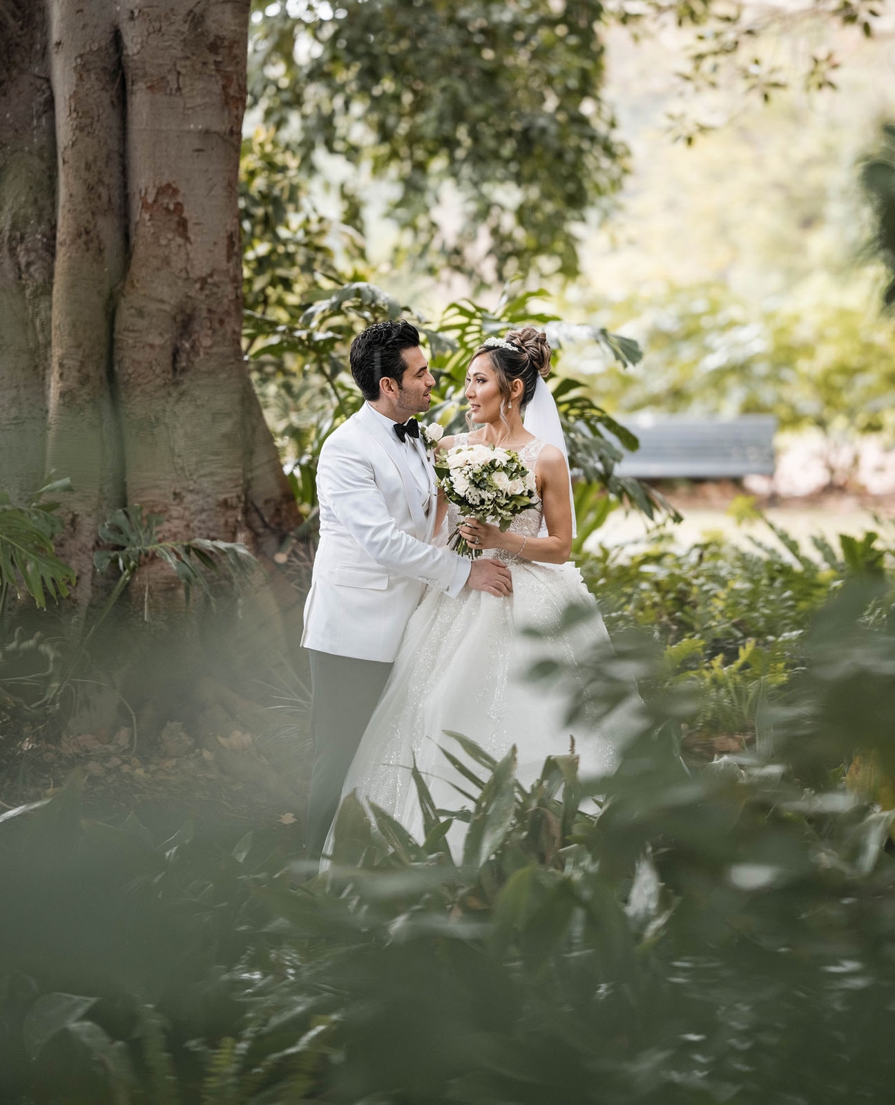adelaide bridal photoshoot and reception - emre & sara 29 Bride and groom through low foliage
