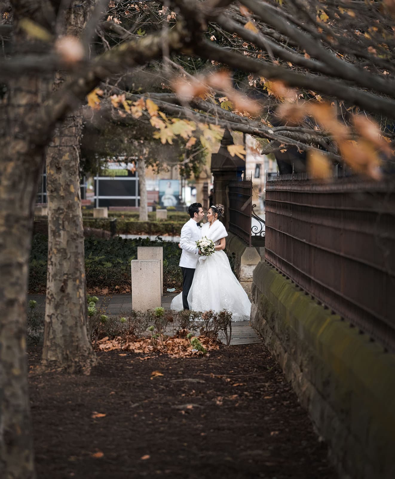 adelaide bridal photoshoot and reception - emre & sara 44 bride and groom under autumnal leaves