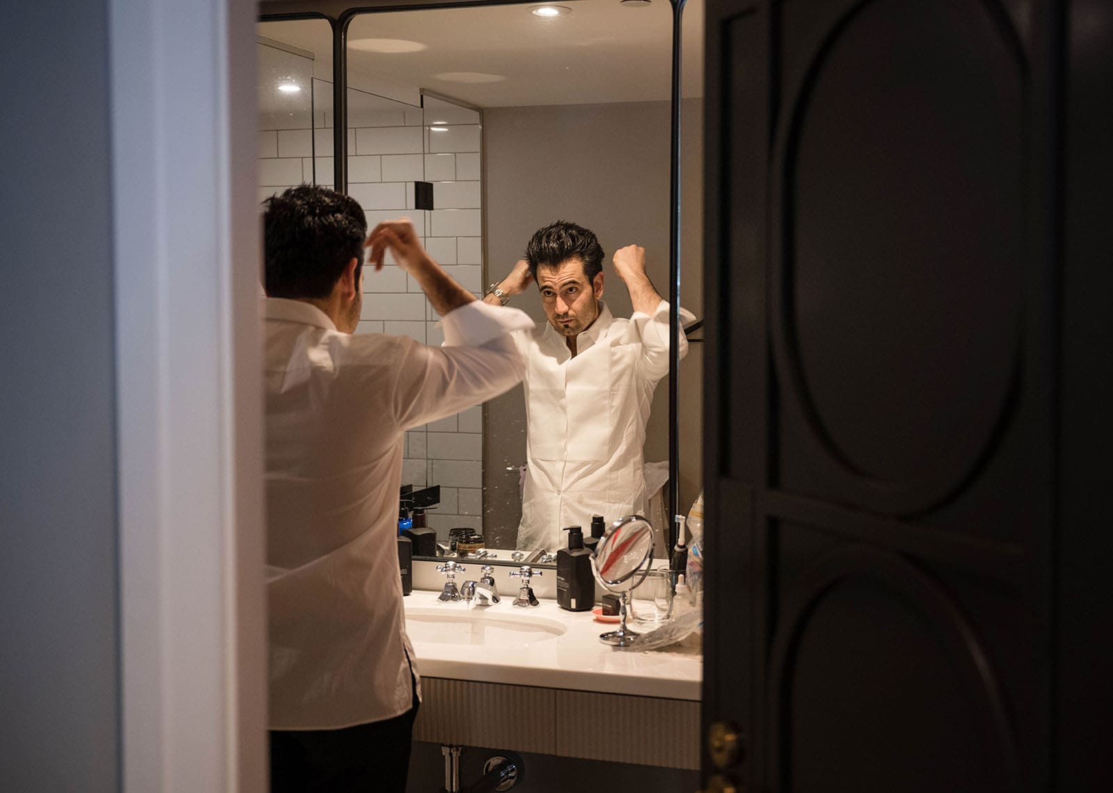 adelaide bridal photoshoot and reception - emre & sara 10 Groom adjusting hair in mirror