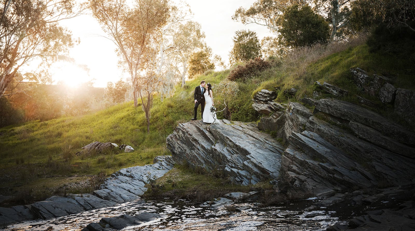 chateau yaldara 5 Bride and groom perched on rocks