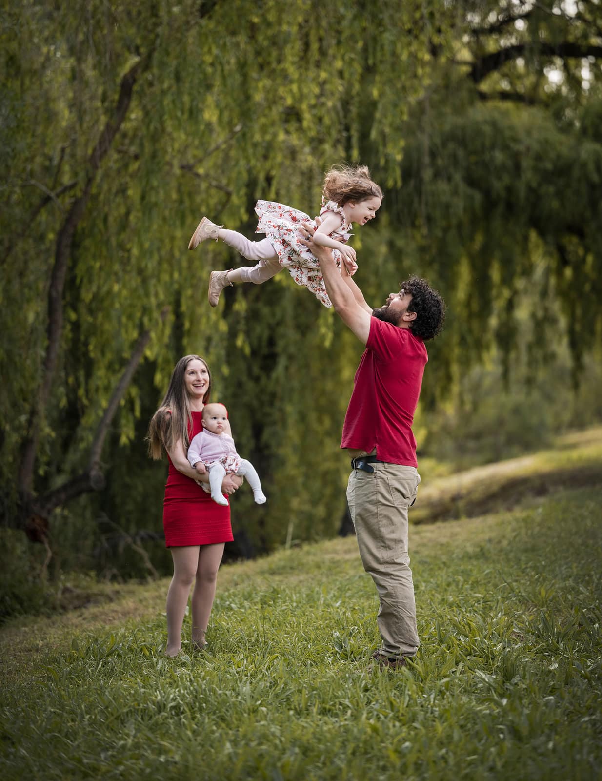 fountain valley reserve family shoot - shaw family 5 Dad throwing little one in sky