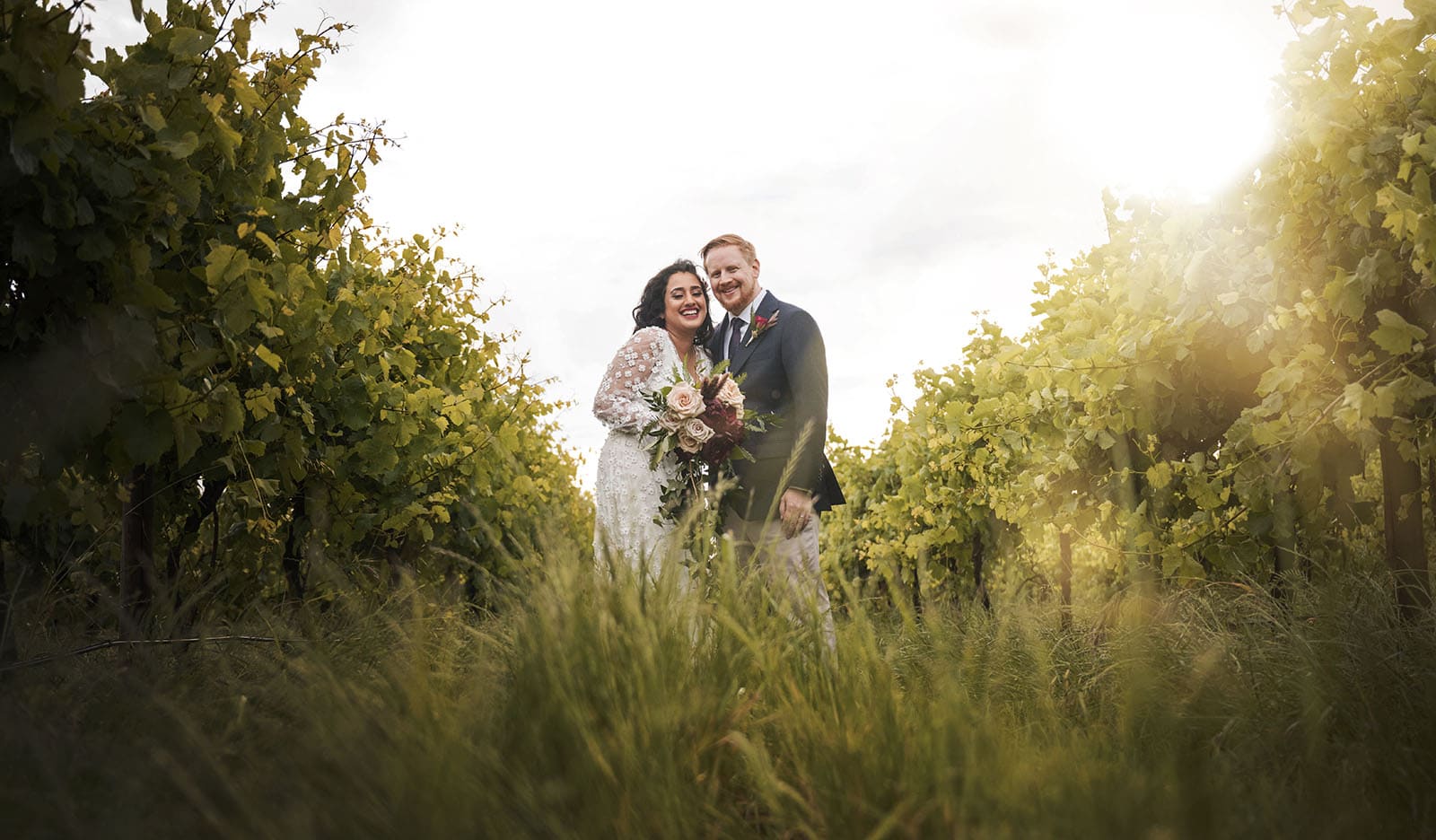 ekhidna winery wedding - chami & bryce 45 Bride and groom in long grass and vineyard