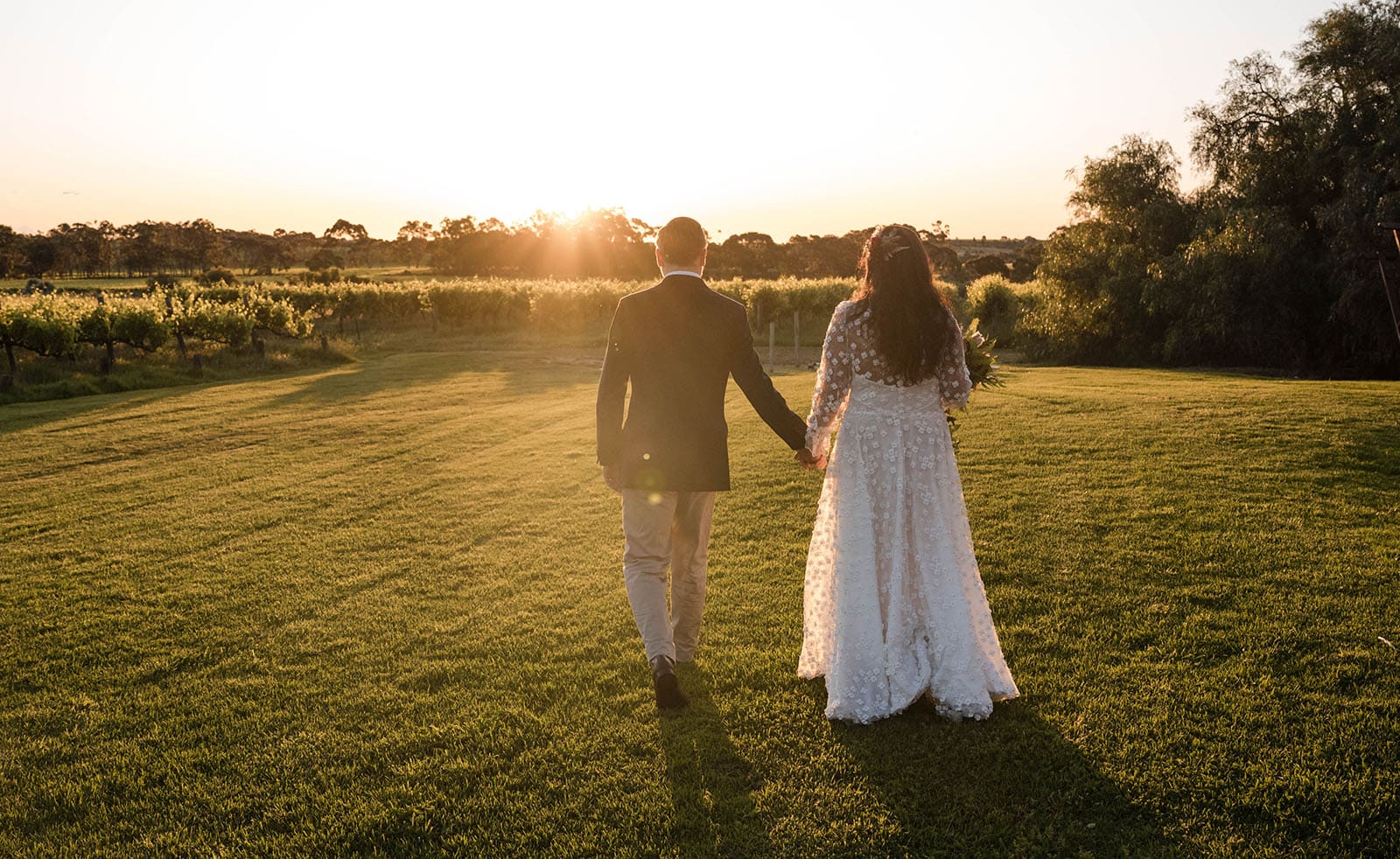 ekhidna winery wedding - chami & bryce 46 bride and groom walking toward sunset