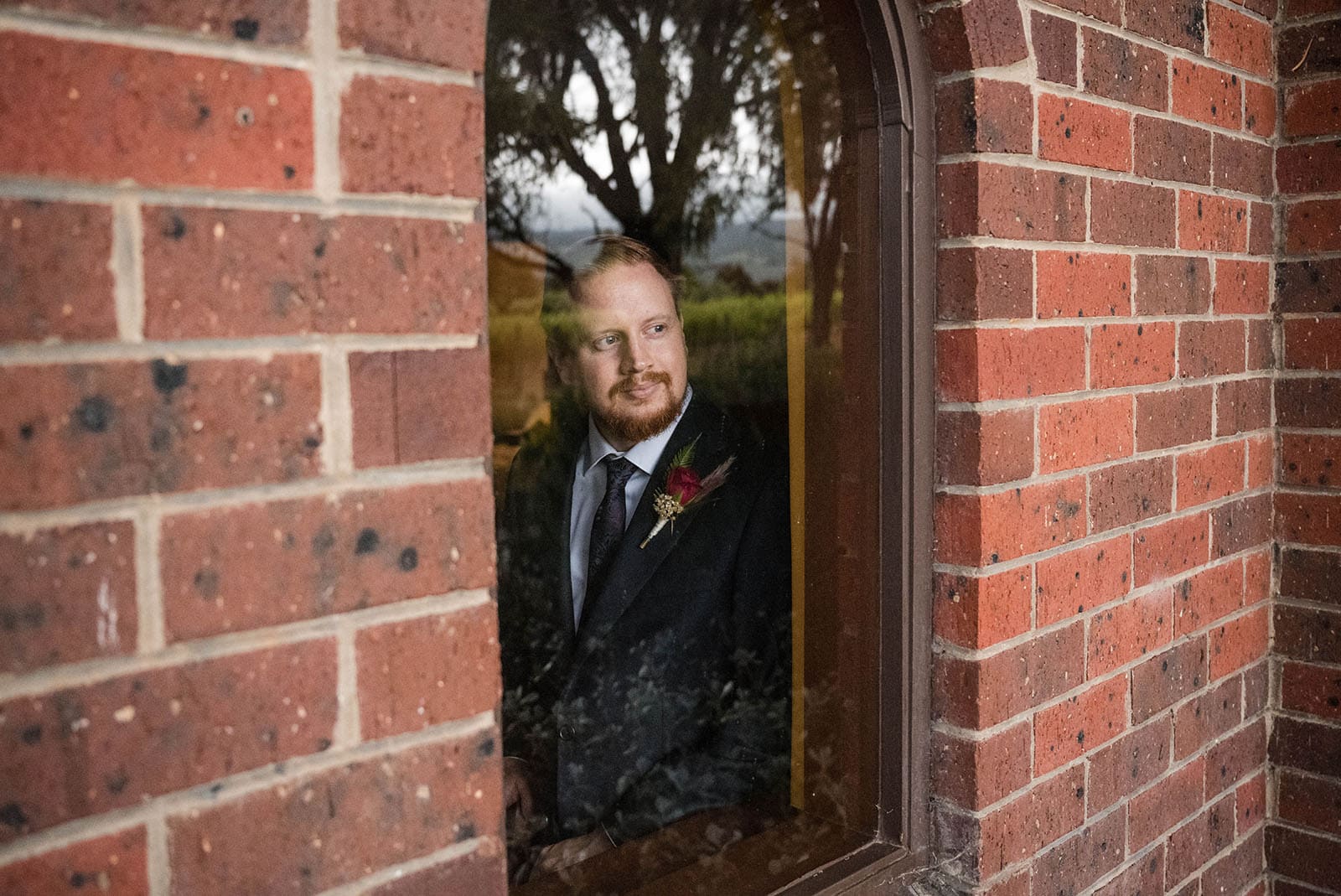 ekhidna winery wedding - chami & bryce 15 Groom peering out window