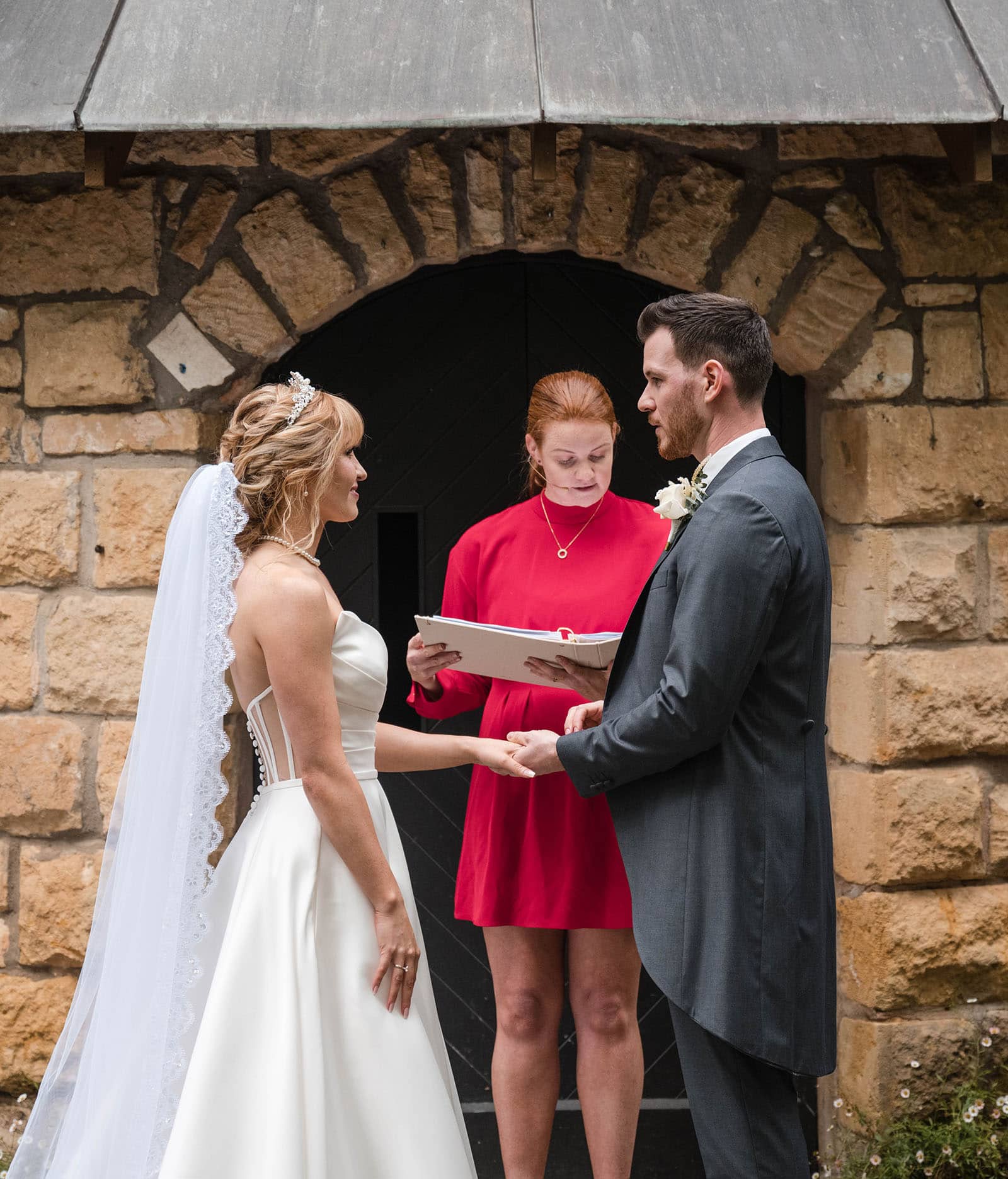 the manor basket range wedding - cassie & danny 38 Bride and groom holding hands in front of chapel