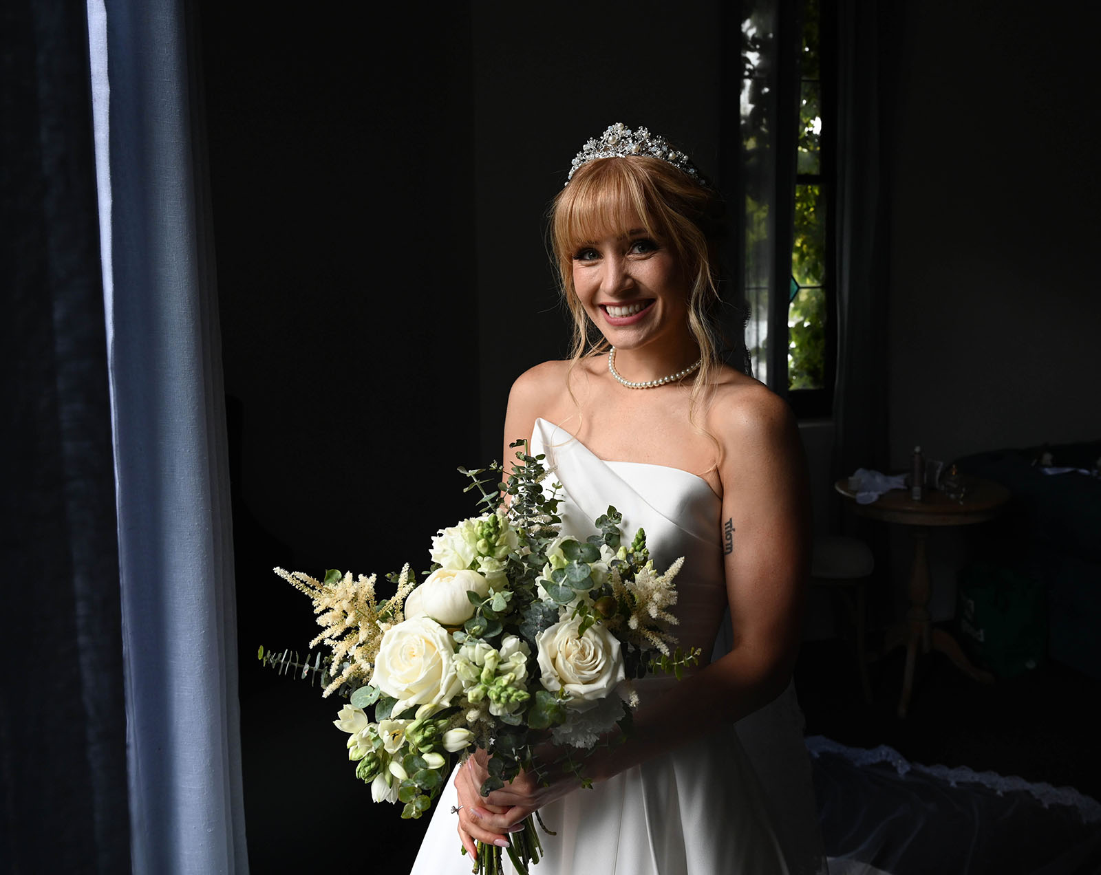 the manor basket range wedding - cassie & danny 27 Bride smiling in window light