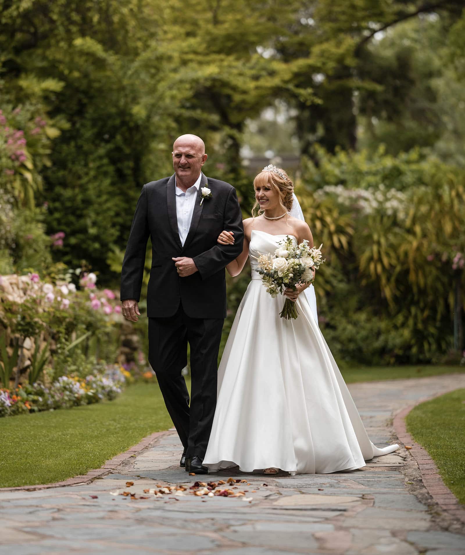 the manor basket range wedding - cassie & danny 30 Bride walking through manor Gardens