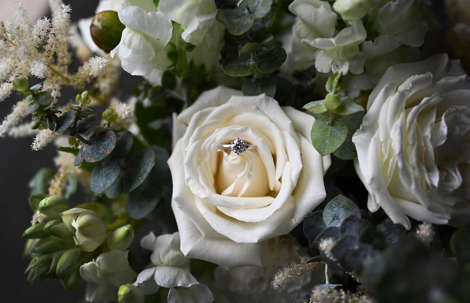 the manor basket range wedding - cassie & danny 13 Engagement ring in white rose bouquet