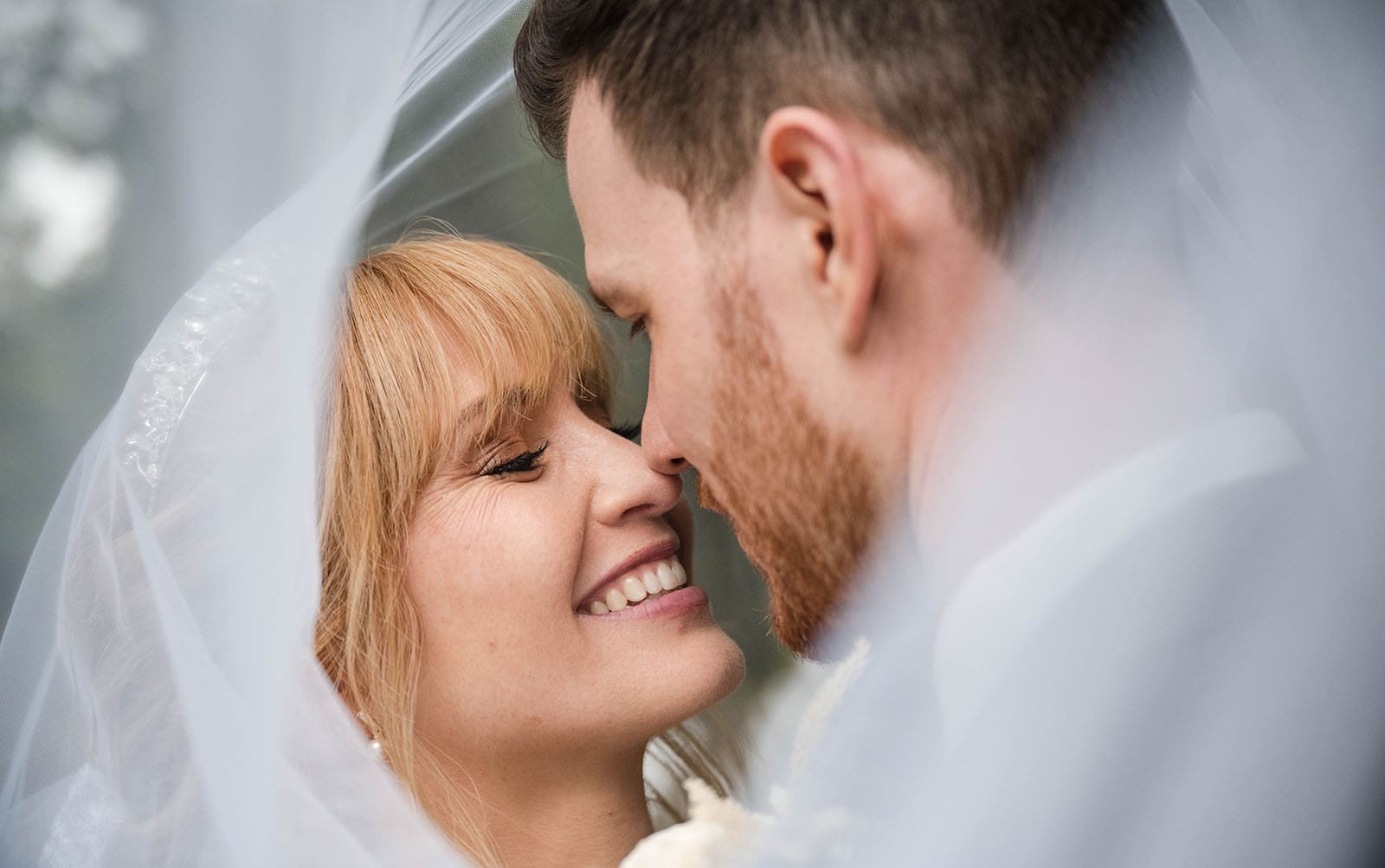 the manor basket range wedding - cassie & danny 47 Smiling bride with groom under veil
