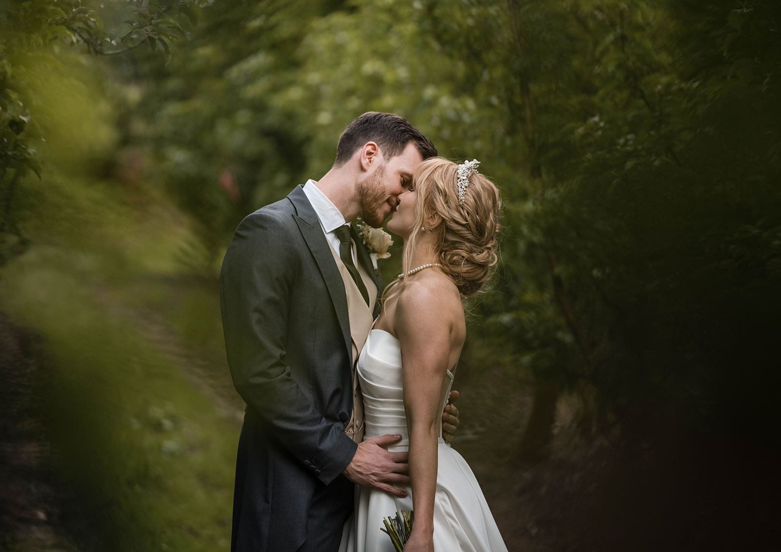 the manor basket range wedding - cassie & danny 60 Wedding day kiss in orchard