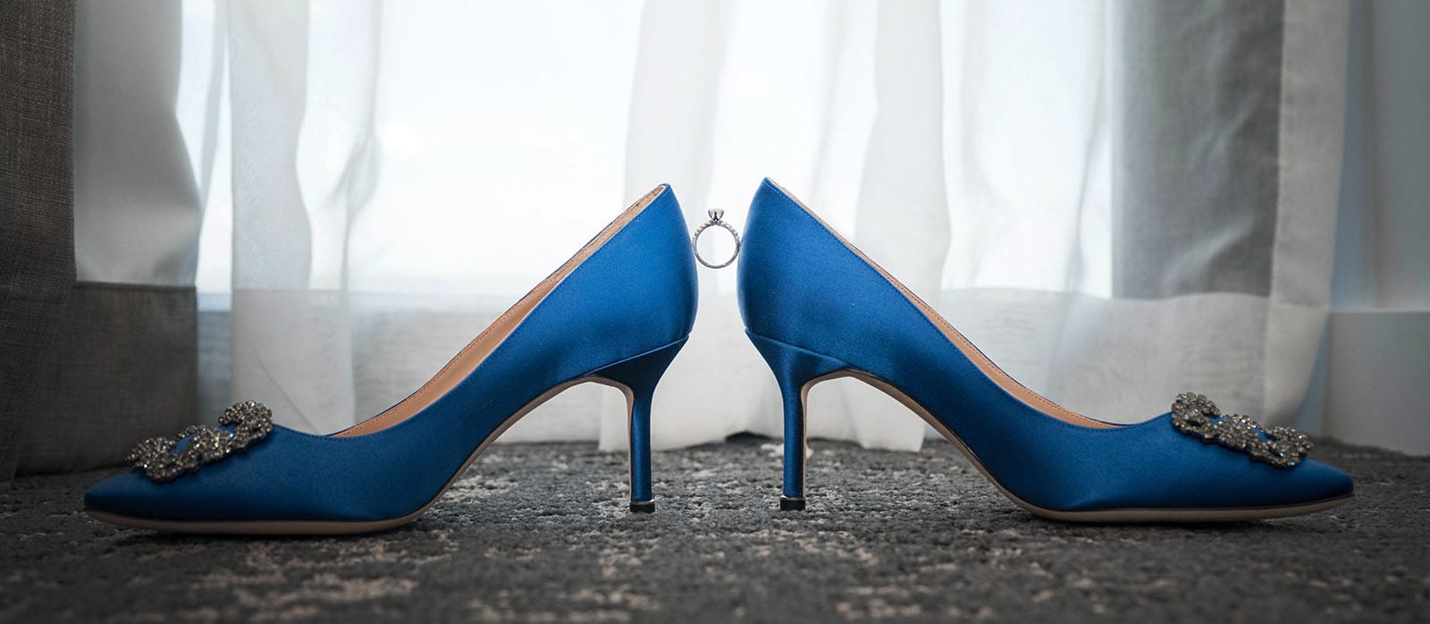 st francis xaviers cathedral wedding - sash & dan 2 Engagement ring perched between two blue shoes