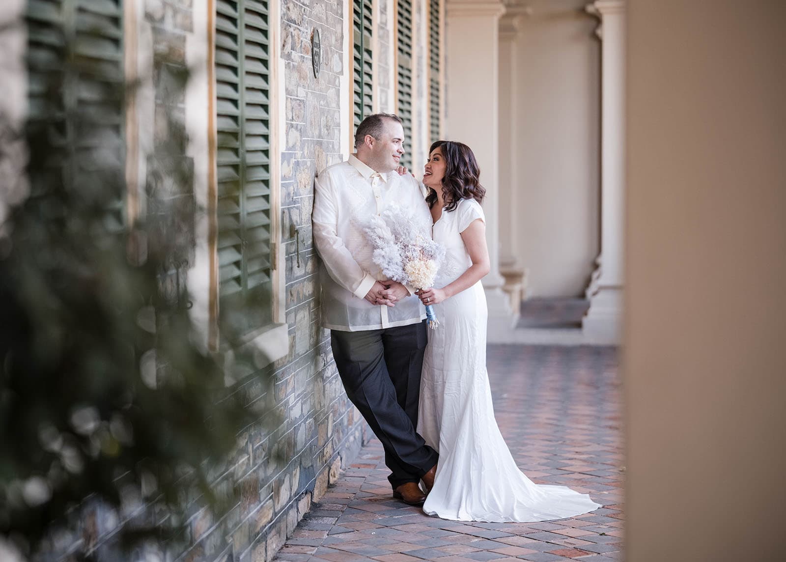 st francis xaviers cathedral wedding - sash & dan 42 Groom leaning on wall talking to bride