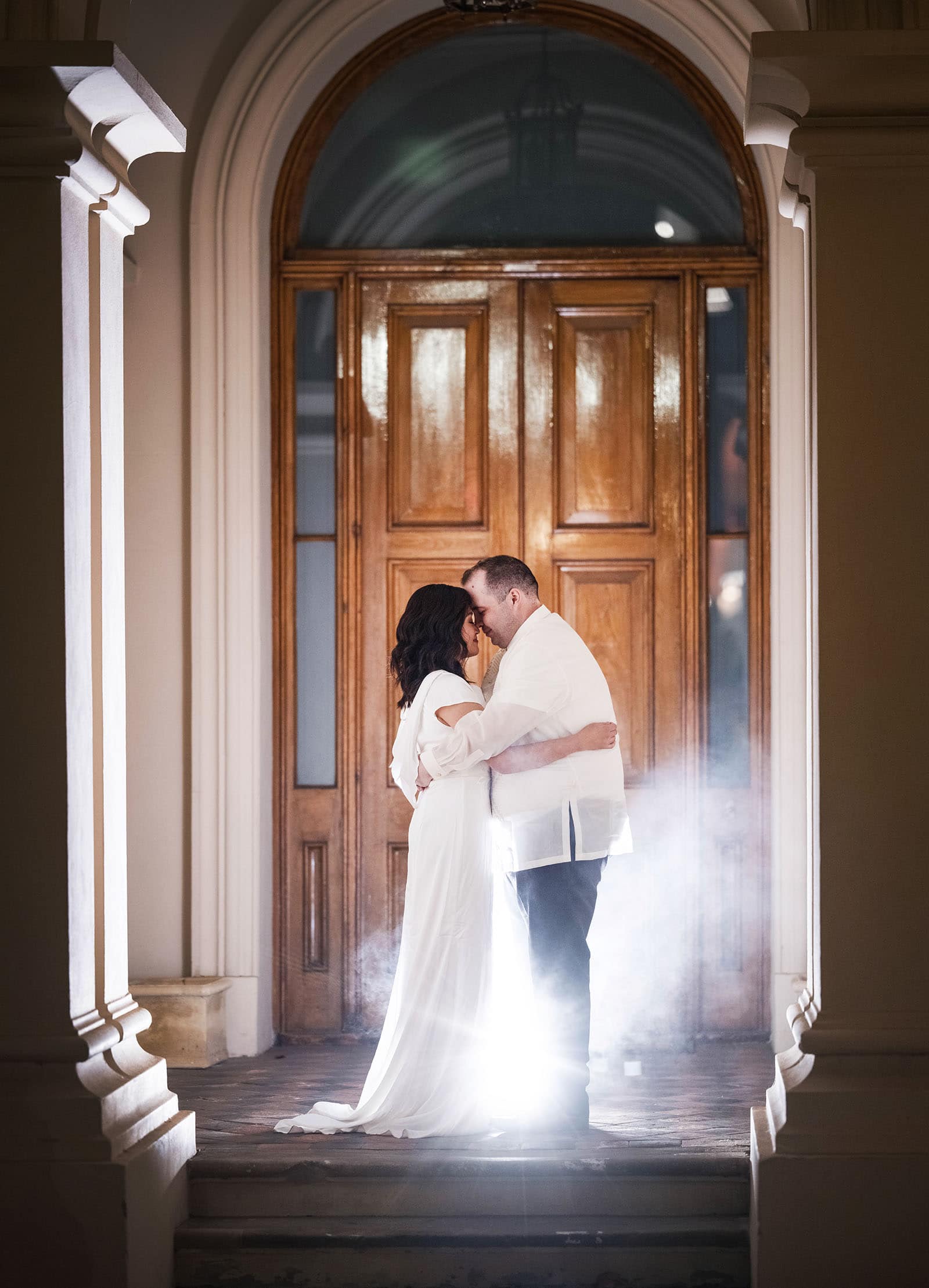 st francis xaviers cathedral wedding - sash & dan 49 Night time photo of bride and groom in doorway