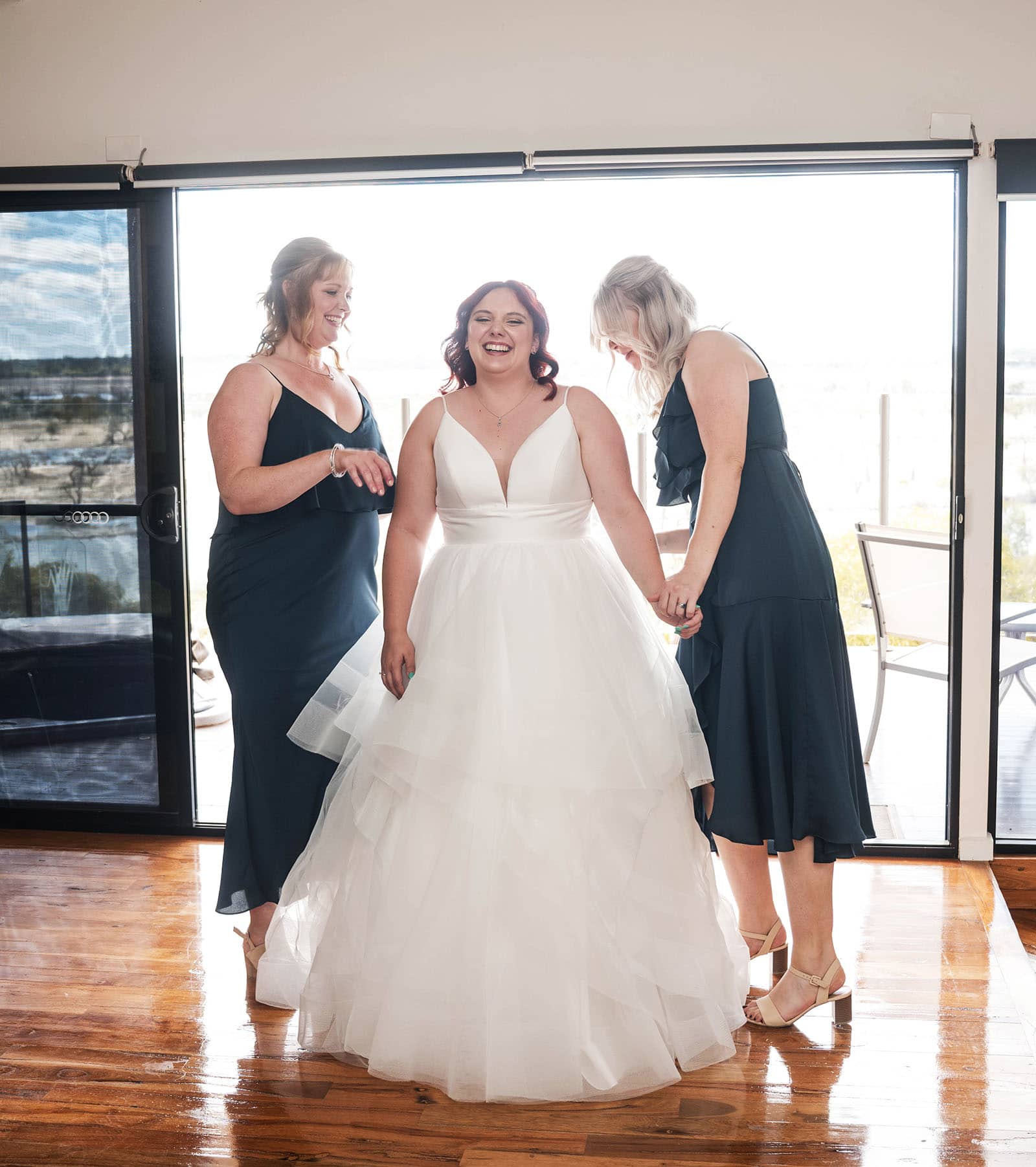 riverland wine centre wedding - lisa & mitch 172 Beaming bride as bridesmaids help