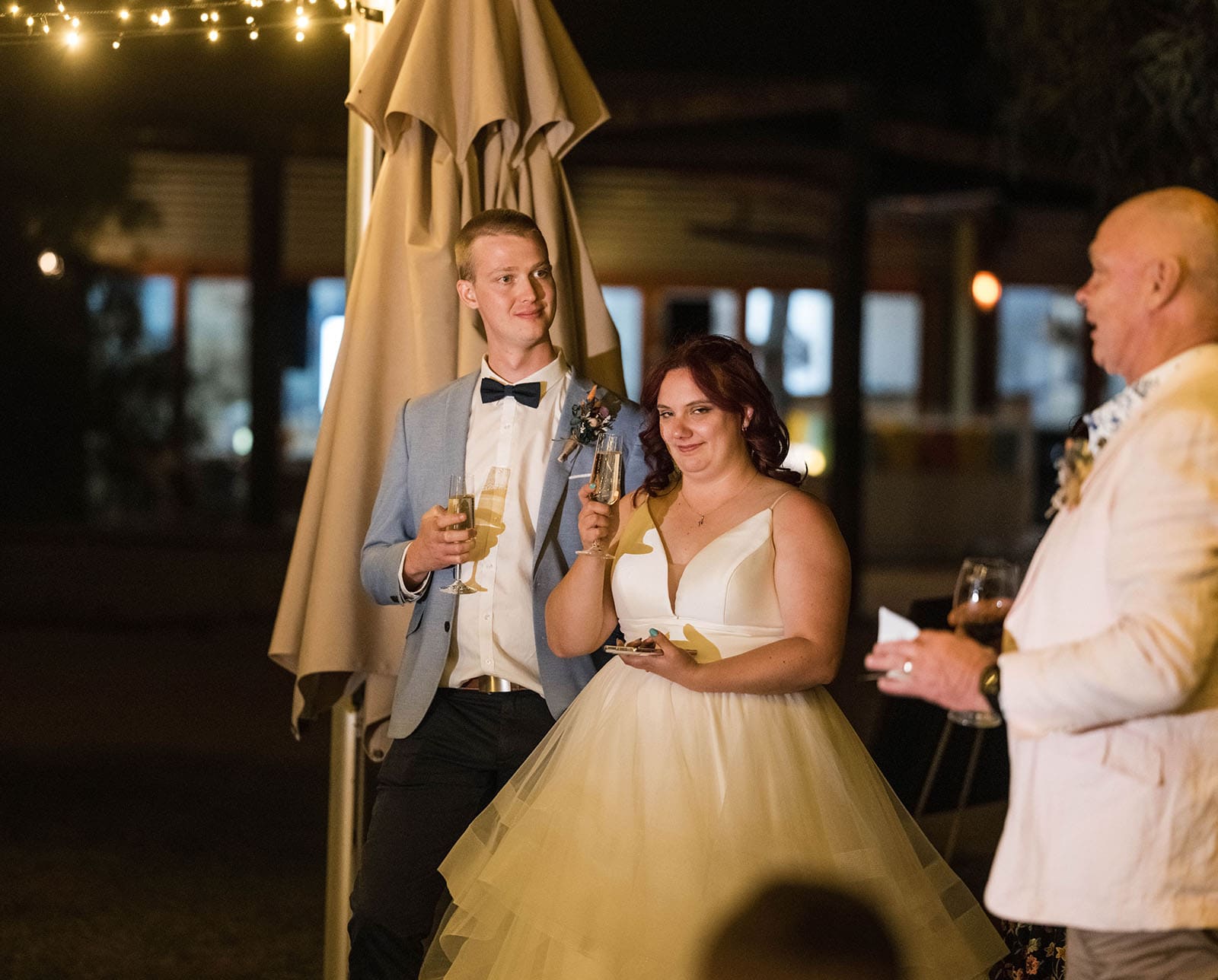 riverland wine centre wedding - lisa & mitch 216 bride and groom listening to speeches outdoors