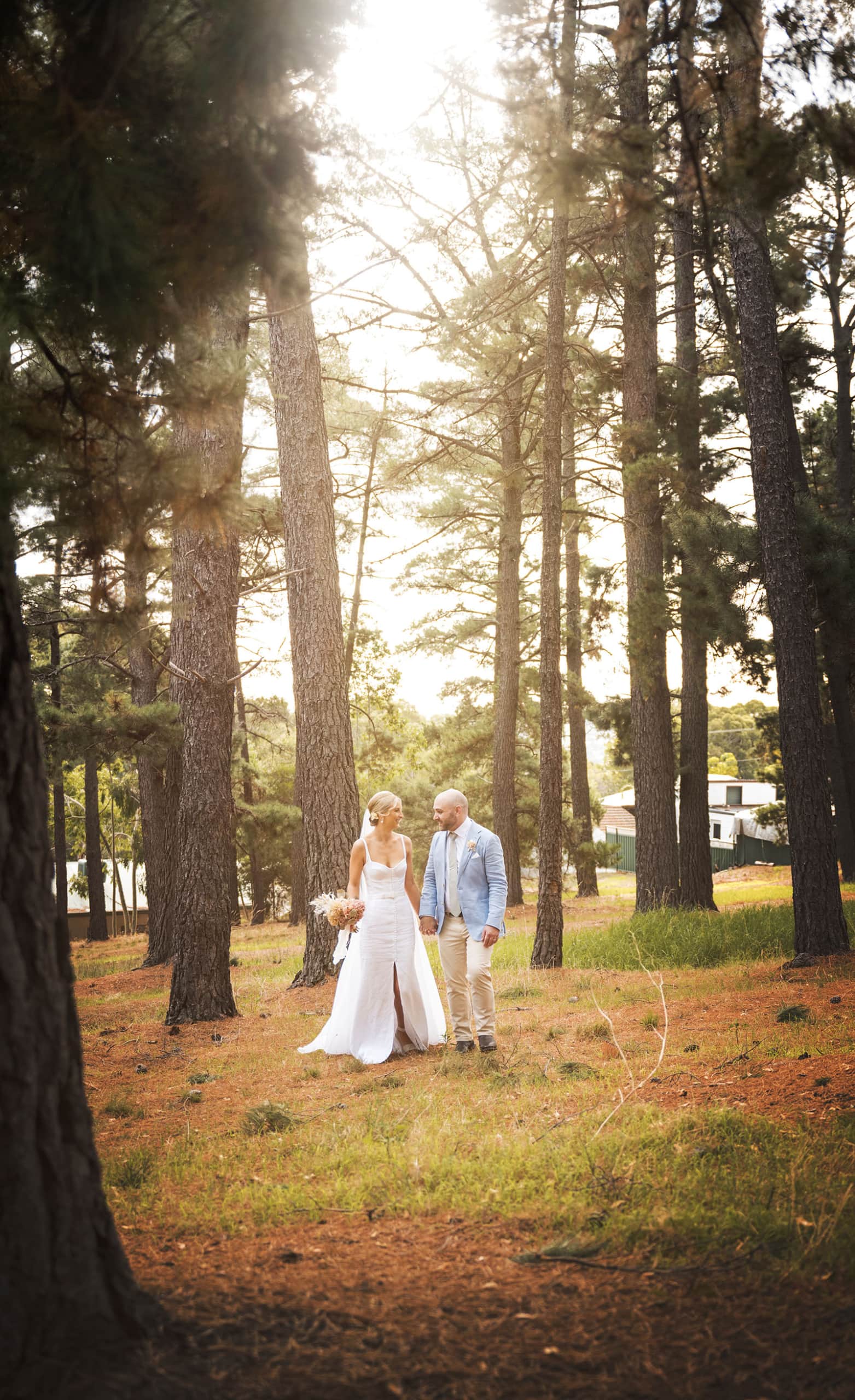 house on haines wedding - danieka & jack 55 Bride and groom under sunlight in pine forest