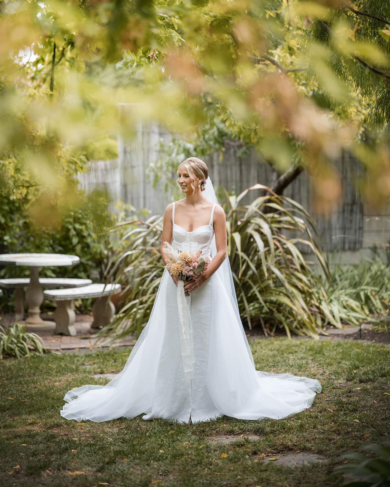 house on haines wedding - danieka & jack 36 Bride standing alone under green leaves