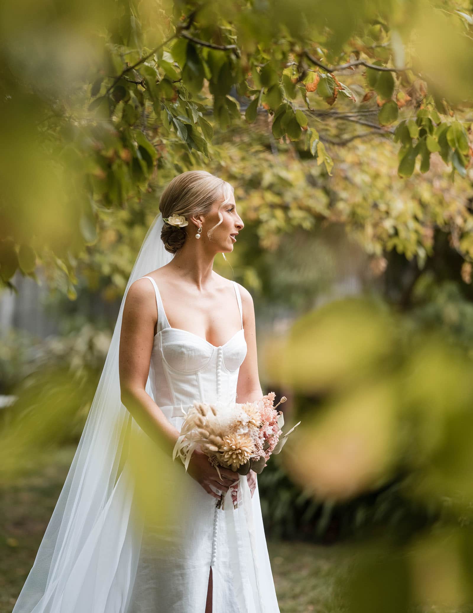 house on haines wedding - danieka & jack 37 Bride standing in green leaves