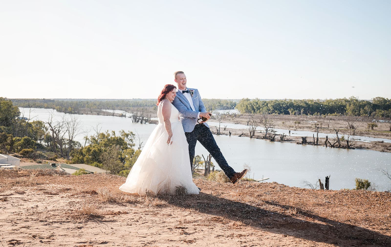 riverland wine centre wedding - lisa & mitch 199 Champagne cork popping on clifftop