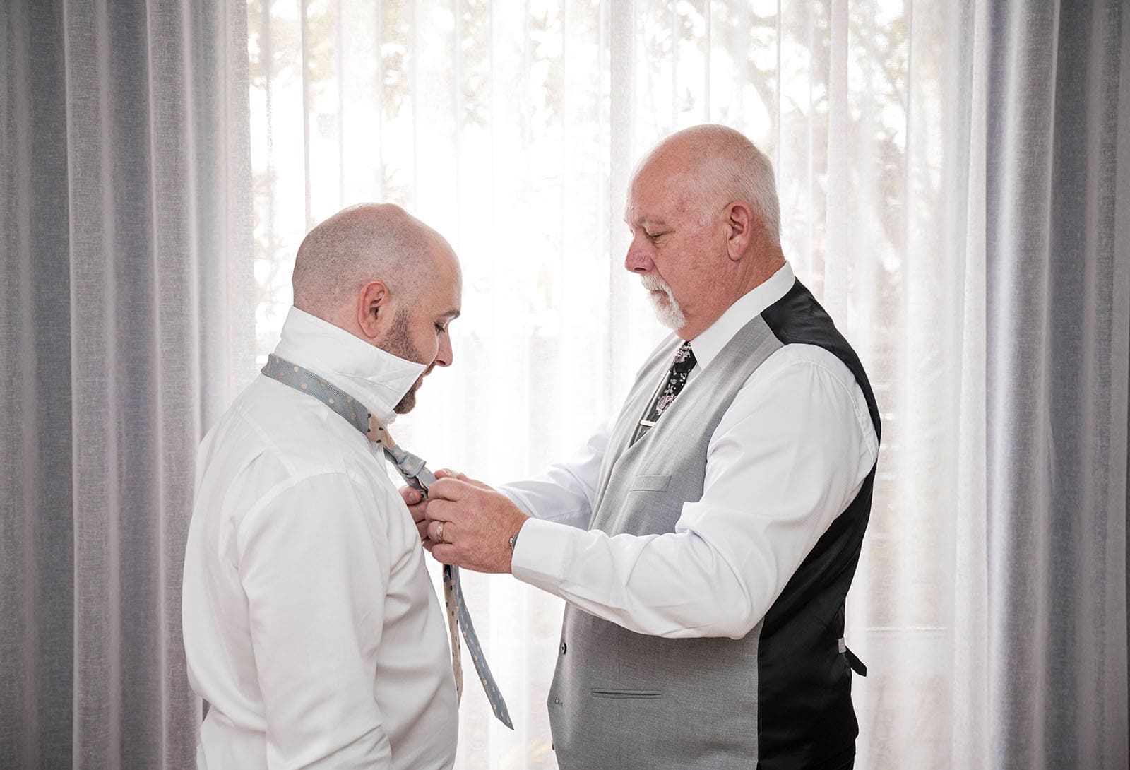 house on haines wedding - danieka & jack 18 Dad helping tie tie in window