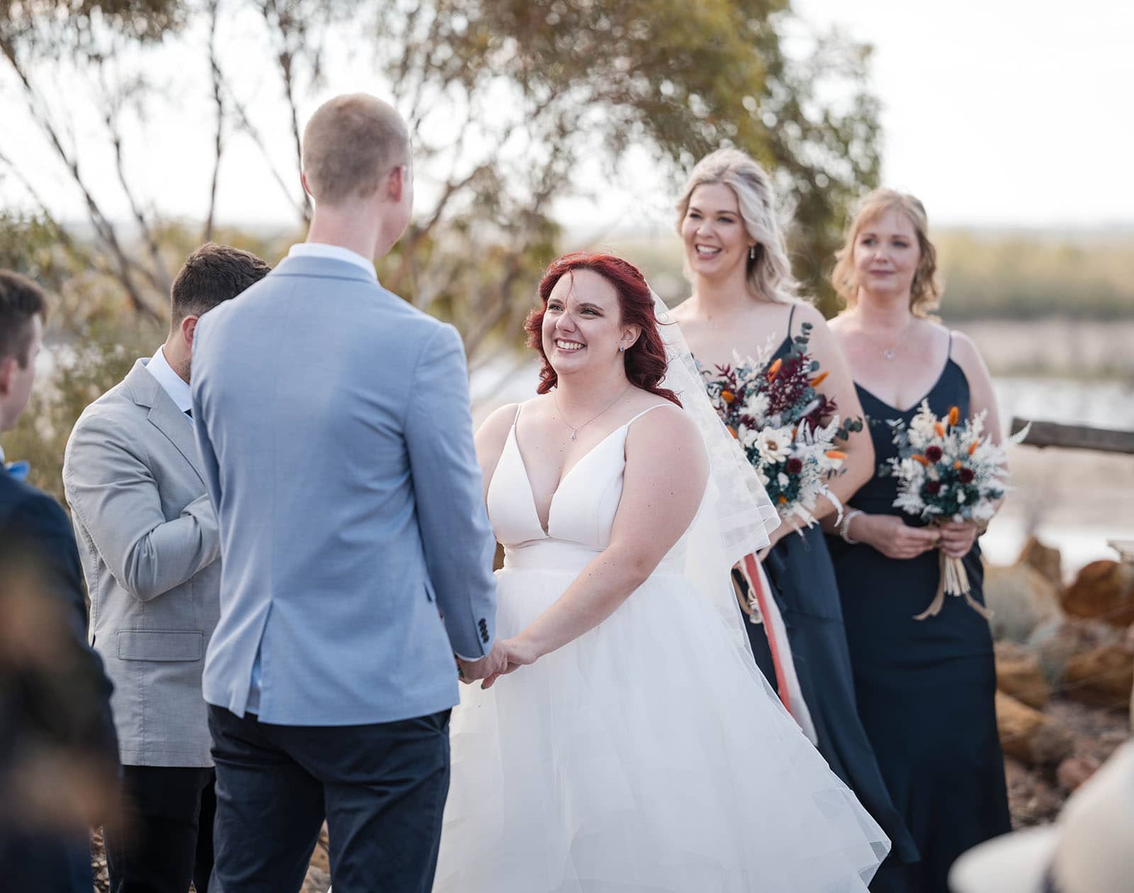 riverland wine centre wedding - lisa & mitch 193 Grinning bride at ceremony
