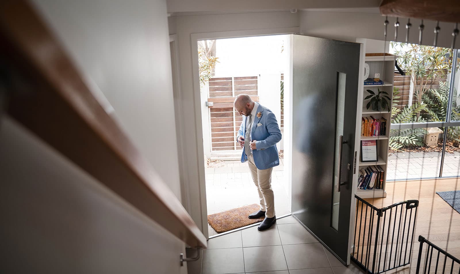 house on haines wedding - danieka & jack 23 Groom buttoning up at front door