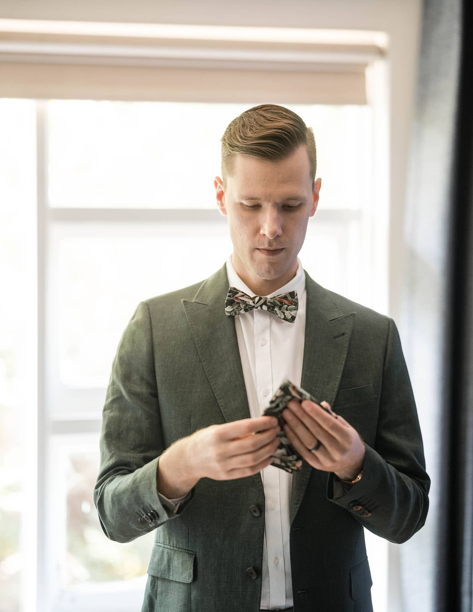 k1 winery wedding - mitch & nick 89 Groom contemplating pocket square