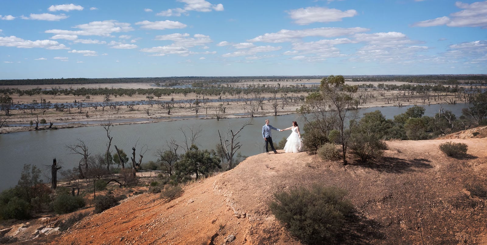 riverland wine centre wedding - lisa & mitch 188 Groom leading bride on cliff
