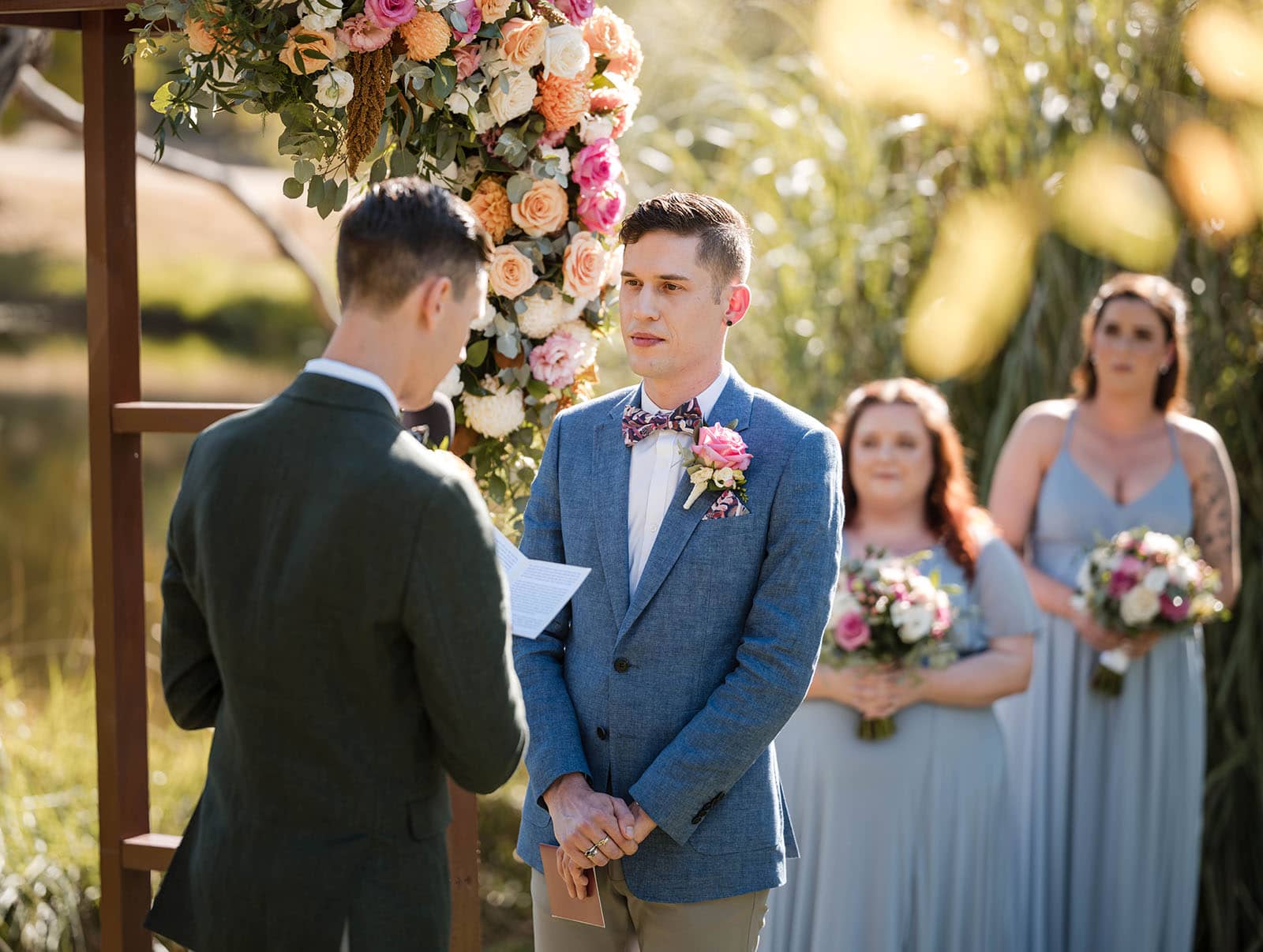 k1 winery wedding - mitch & nick 114 Groom listening to his groom's vow