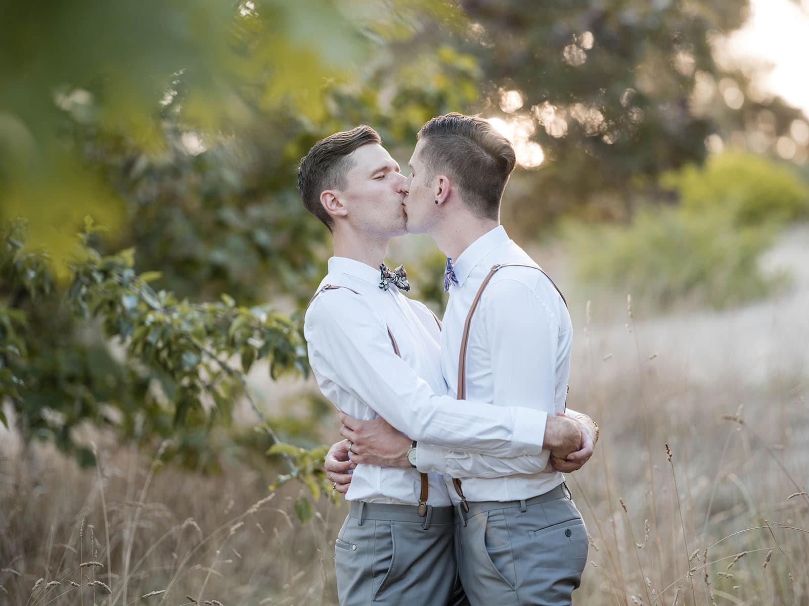k1 winery wedding - mitch & nick 136 Grooms kiss together in trees