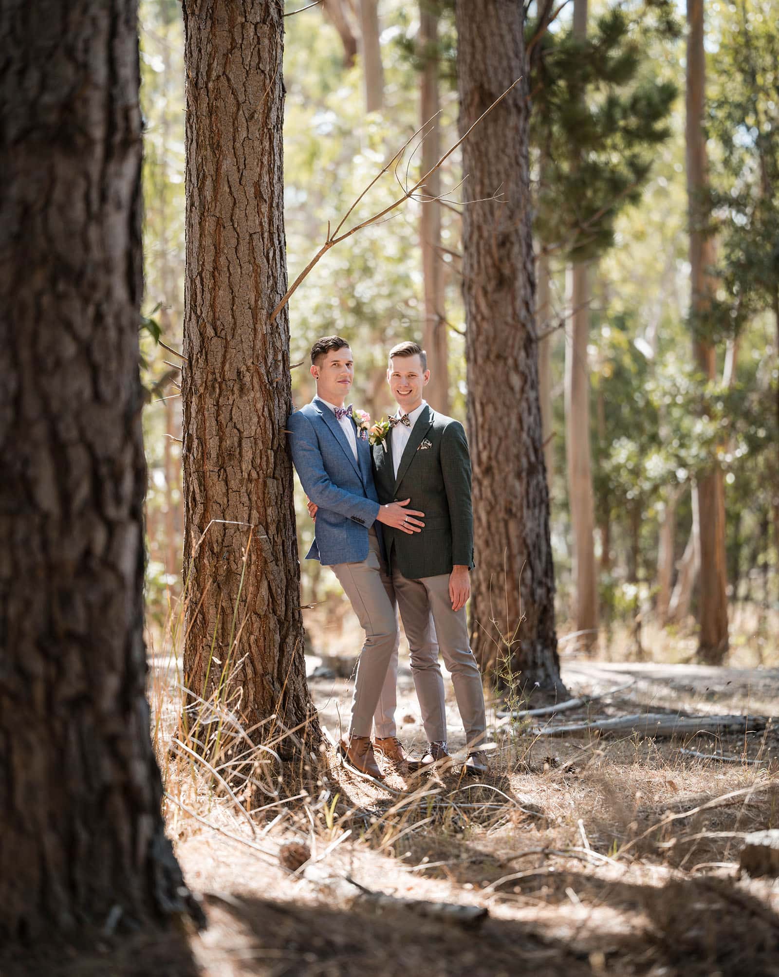 k1 winery wedding - mitch & nick 98 Grooms together leaning on pine tree