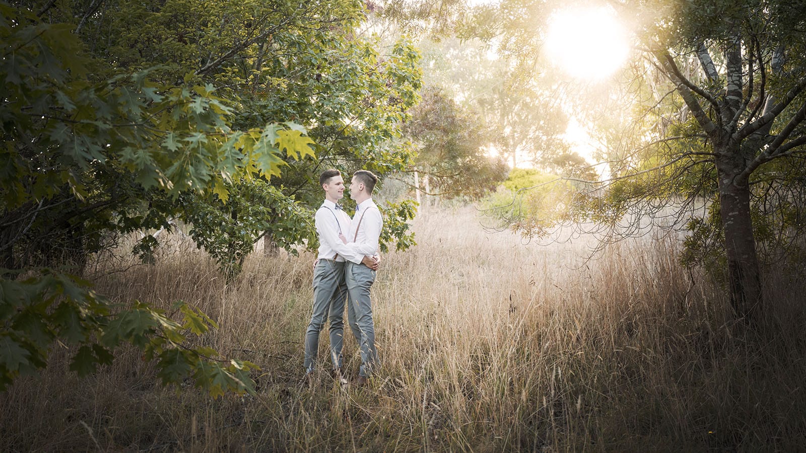 k1 winery wedding - mitch & nick 135 Grooms under sun in long grass